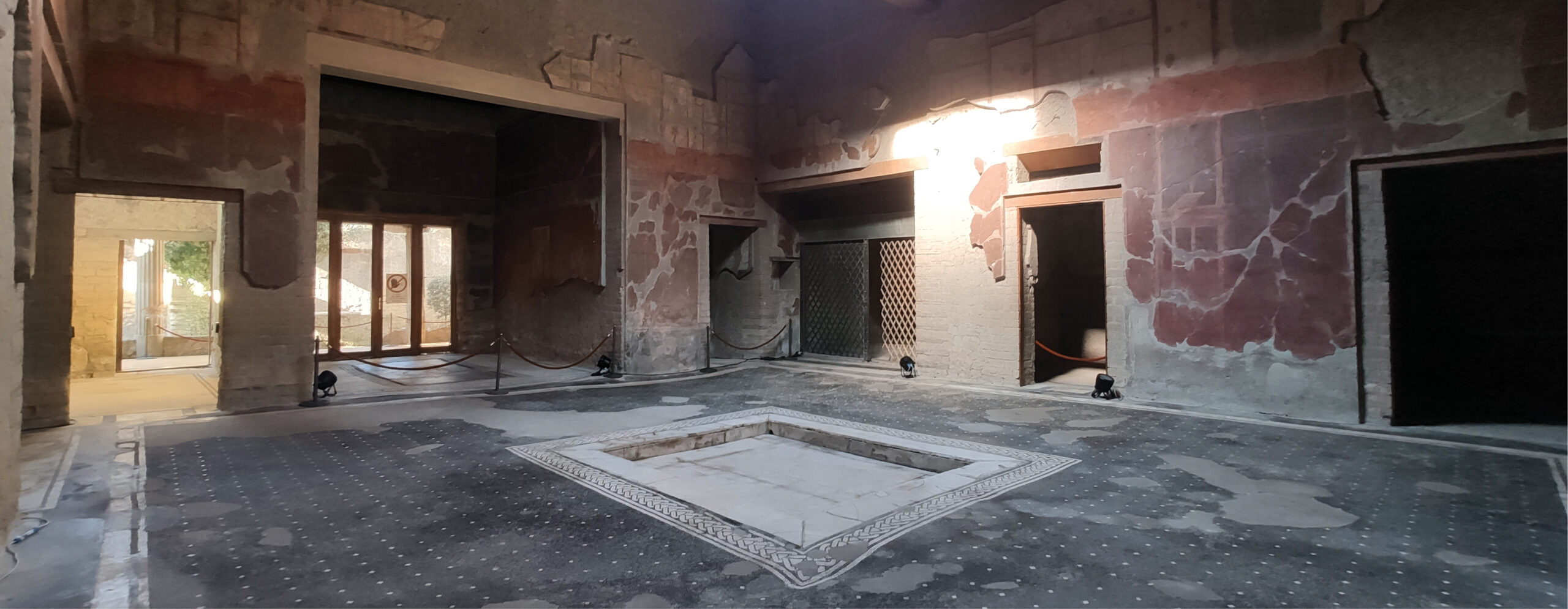 below The House of the Bicentenary has a fairly classic layout for a Roman house of the time. Entering the central atrium (shown here) from the front door, visitors would have seen several rooms off to each side. The views through the house focused on the connection to the tablinum (at the back), and the peristyle garden beyond.