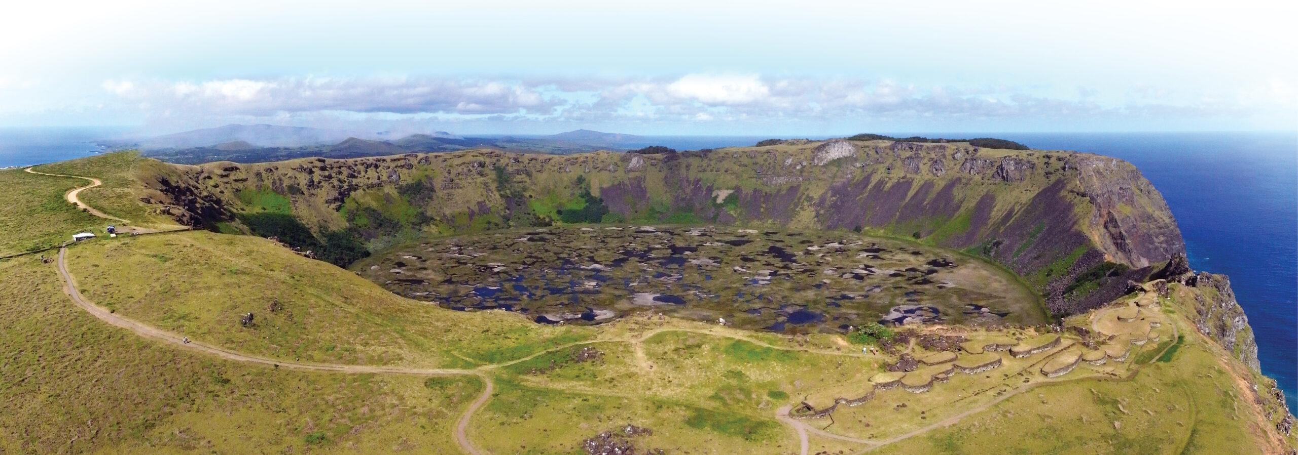 left Panoramic view of the crater Rano Kau with Orongo village, centre of the birdman cult on Easter Island. inset Painted slab with facing birdmen belonging to the collections of the Museo Antropológico Padre Sebastián Englert (MAPSE) Easter Island.
