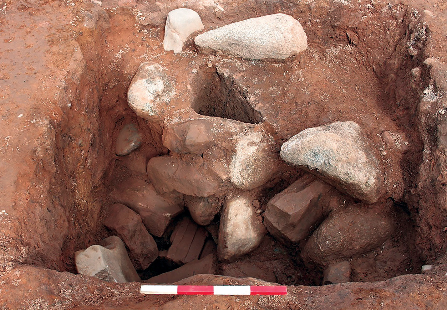left The remains of the Classical temple excavated outside Maryport Roman fort, as well as the earlier ditch over which it was built. The two columns in antis of the façade can be seen in the foreground. right The pit in which the ‘new’ altar was found. The square post-pipe has been half sectioned on the diagonal, and part of the stone post-packing has been removed, revealing the top of the altar. Its discovery was key to understanding that the altars had not been buried for ritual reasons, but had been recycled as packing material for a monumental building.