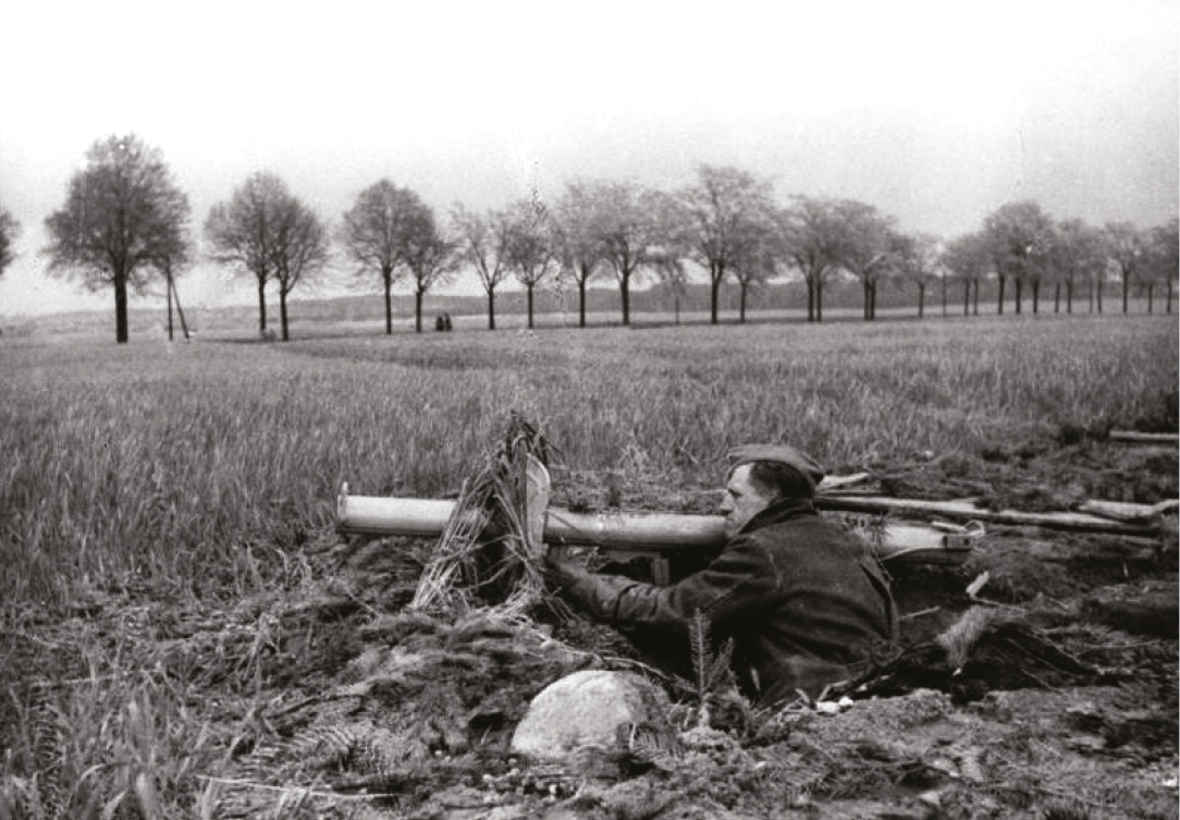 ABOVE Member of the Volkssturm (Home Guard) armed with a Panzerschreck, the late-war German bazooka. RIGHT One of the most-famous pictures from the Battle of Berlin two Volkssturm recruits, young and old, await the Soviets in a trench armed with Panzerfausts, the short-range, single-use, anti-tank rocket.