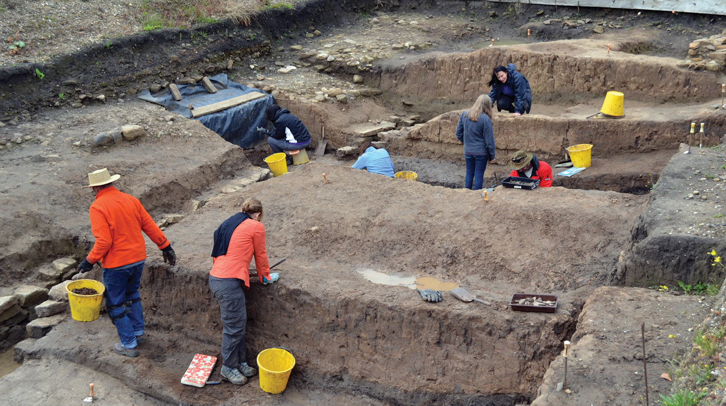 right Deep layers of clay had been used to level up the ground for a Roman road (visible along the left side of the trench) in an area outside the south-west corner of the South Shields fort. More clay was dumped when the early 3rd-century supply base was built, sealing finds such as this sculpted head (inset), depicting a protective deity (tutela).