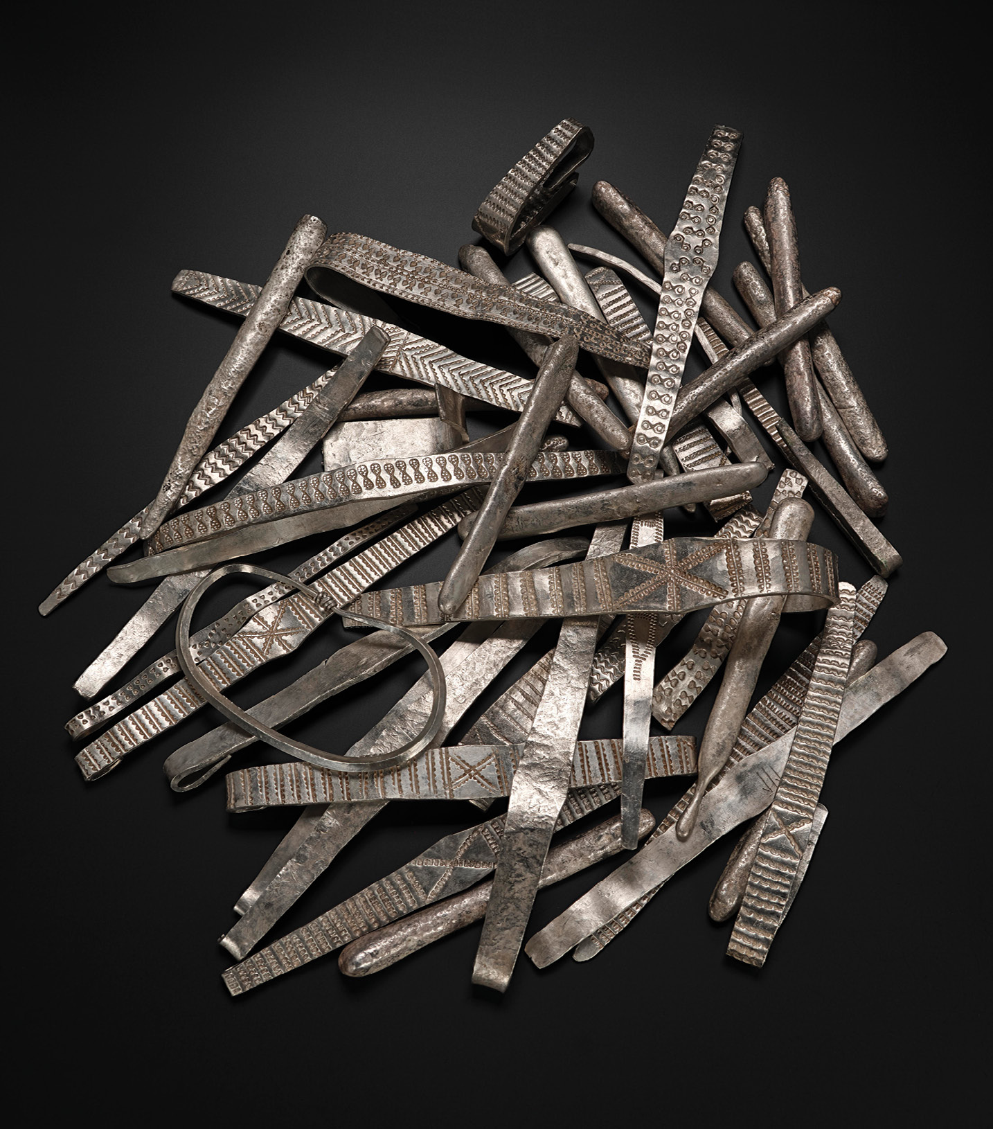 LEFT Silver bullion from the lower, much richer, layer of the Galloway Hoard, included silver ingots and arm rings four of which were marked with Anglo-Saxon runes, a surprising find on objects traditionally described as ‘Viking’.