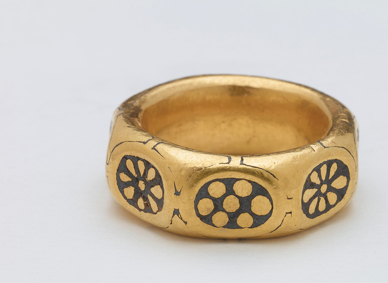 BELOW A chunky octagonal gold finger ring (external diameter: 29.4-30.3mm) was also among the recovered artefacts; its decorations place it in the 9th century. RIGHT This arm-ring or bracelet is closed by a stylised animal head apparently biting its own tail; it is probably of 9th-century Anglo-Saxon manufacture. Its external diameter is 86.4mm by 74.9mm.