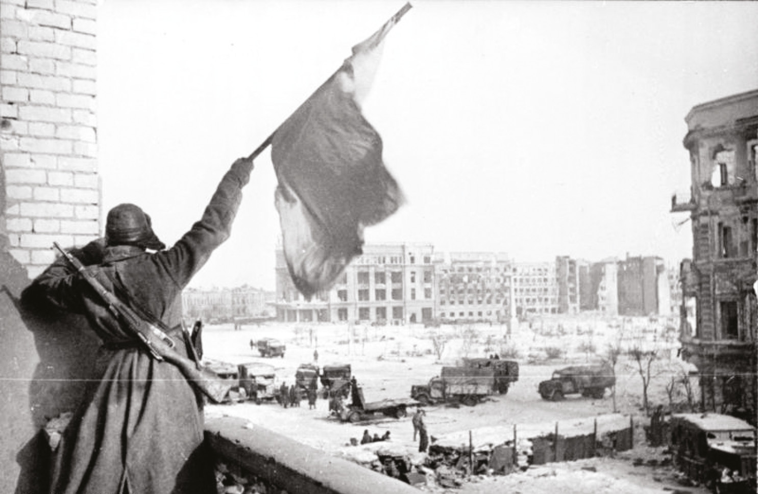 above Victory. A Soviet soldier waves the Red Flag over the ruins of Stalingrad.