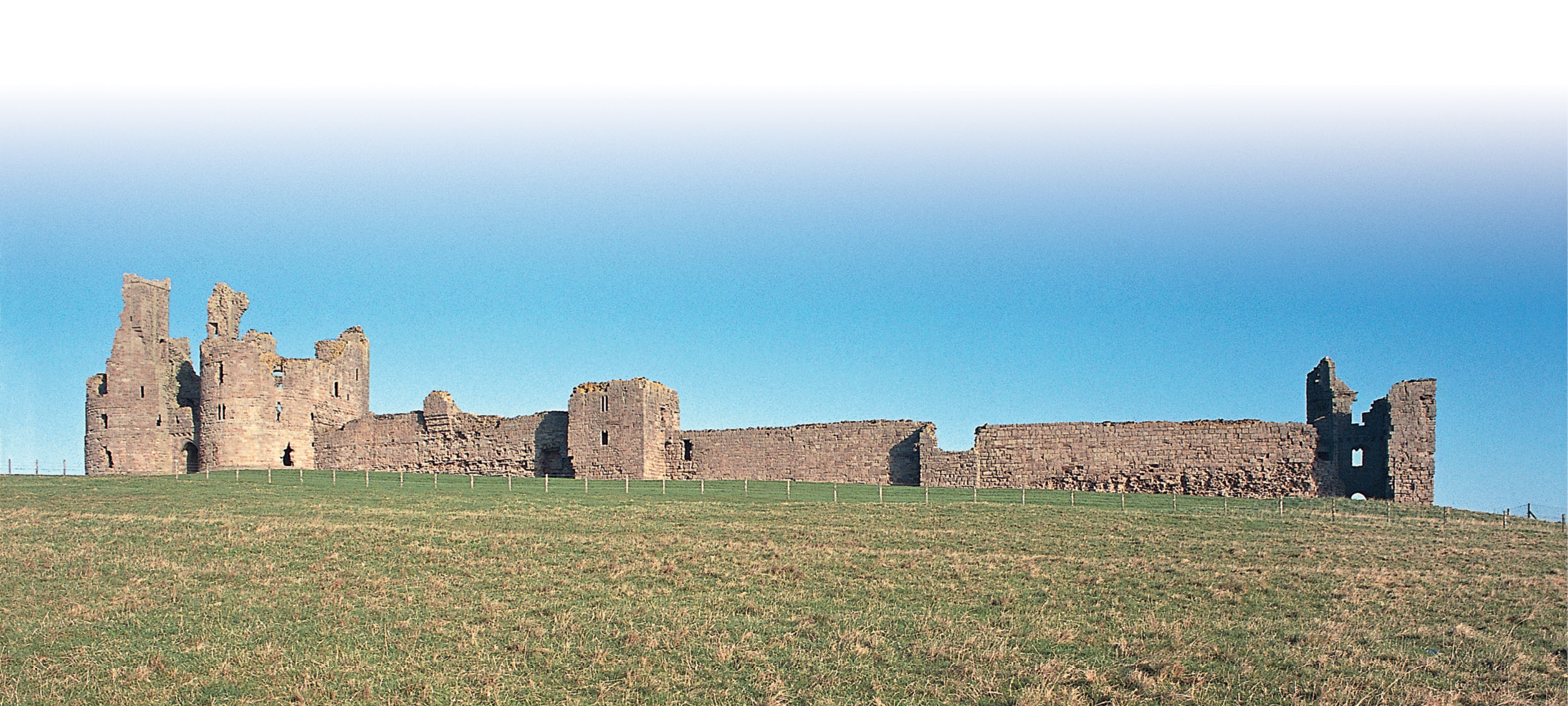 below Dunstanburgh Castle lies10km south of Bamburgh Castle. Defensive practicality here was less important than allusion to the Avalon of Arthurian legend; the only time the castle was seriously threatened was during the Second World War.