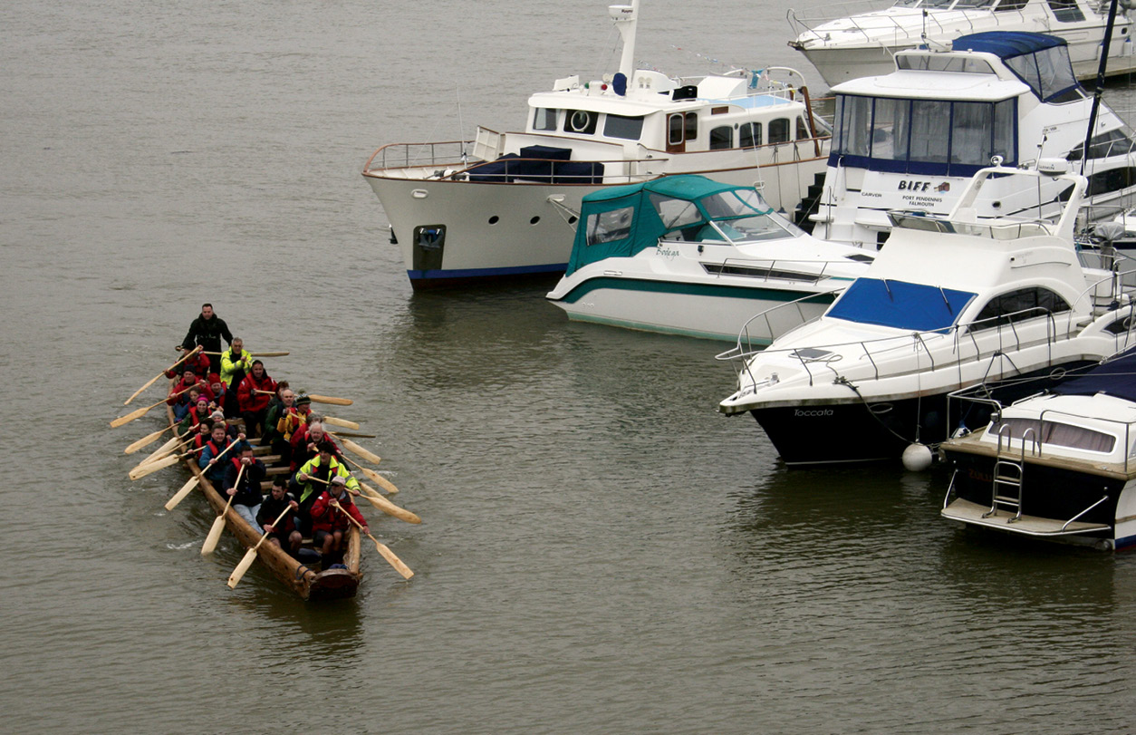 above RIGHT Passing rather more modern vessels, the crew return in triumph from their successful maiden voyage.