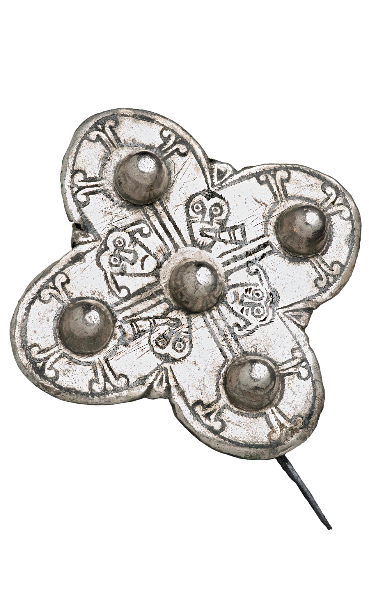 left One of two Late Anglo-Saxon silver quatrefoil brooches depicting two of the five senses sight and hearing. On this example exaggerated ears are ringing from the blowing of blast horns.
