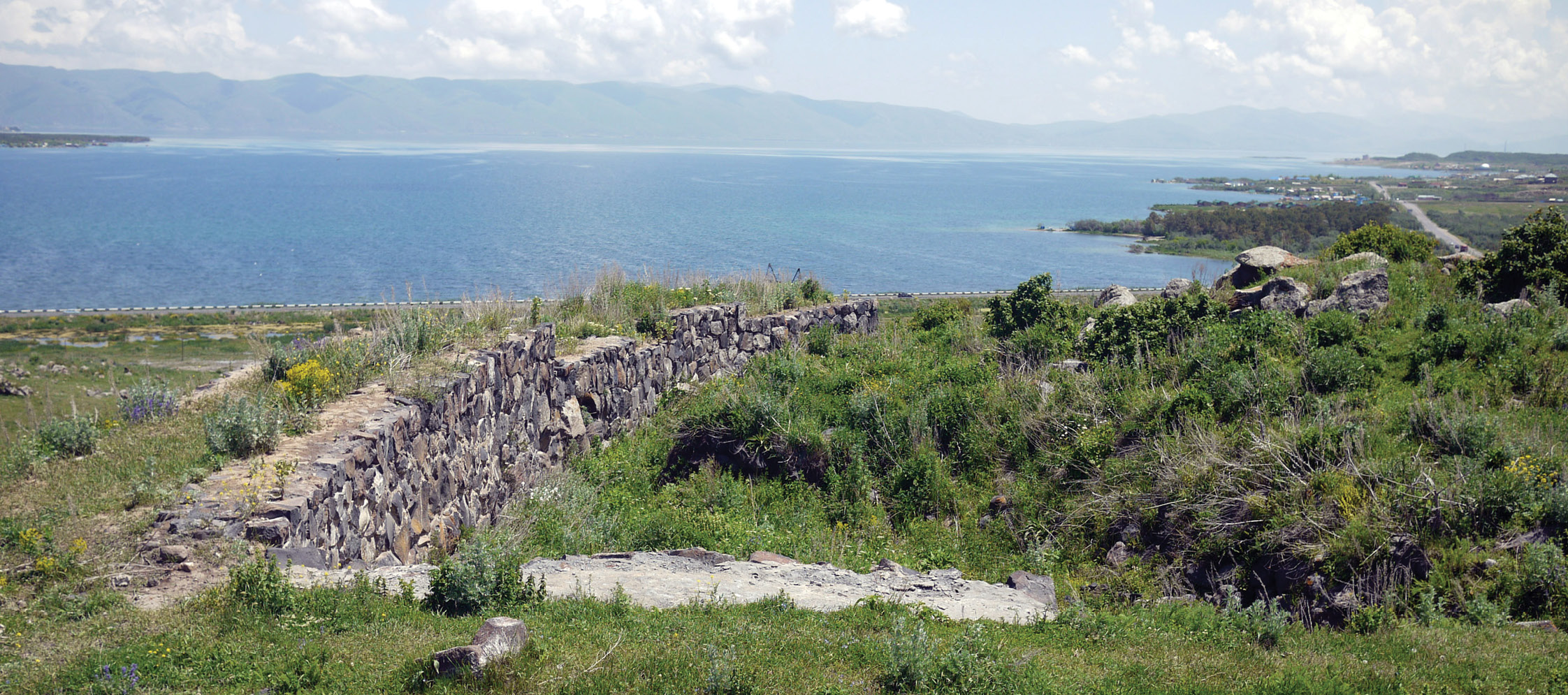 top Lake Sevan, as seen from the Lchashen hillfort, and the view of the barrow field (Inset) that was revealed when the water level was lowered by the Soviets.