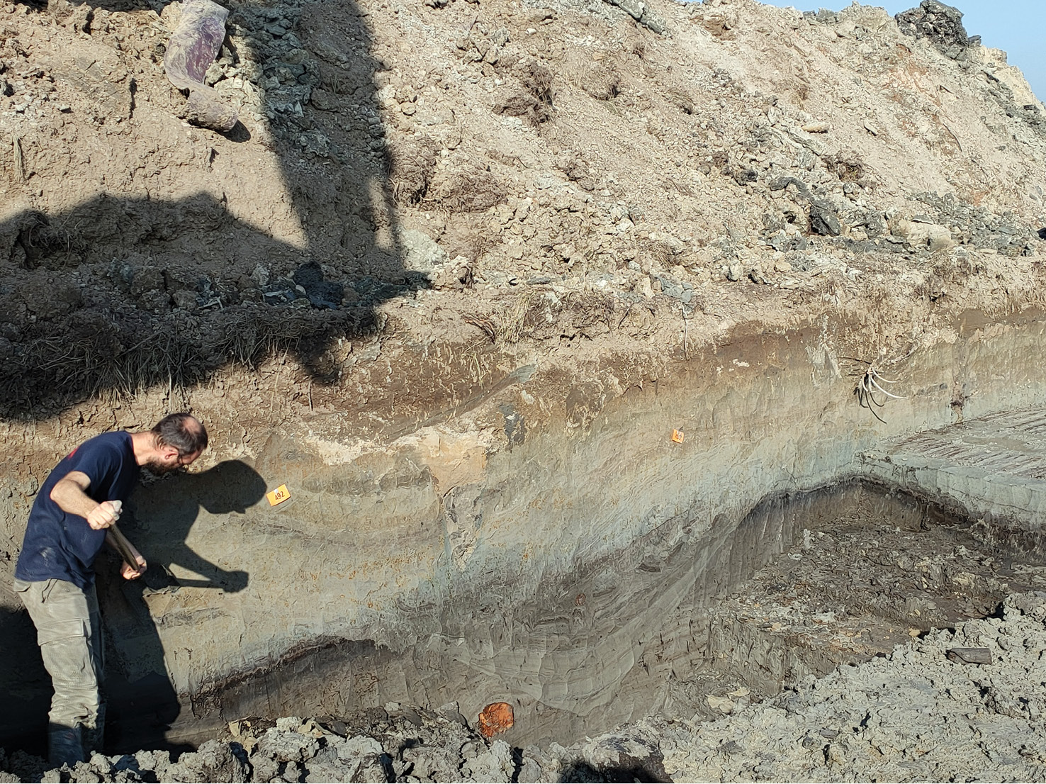 left Exposing the V-ditch in profile. The wooden supports for the rampart are visible to the far right of the photograph.
