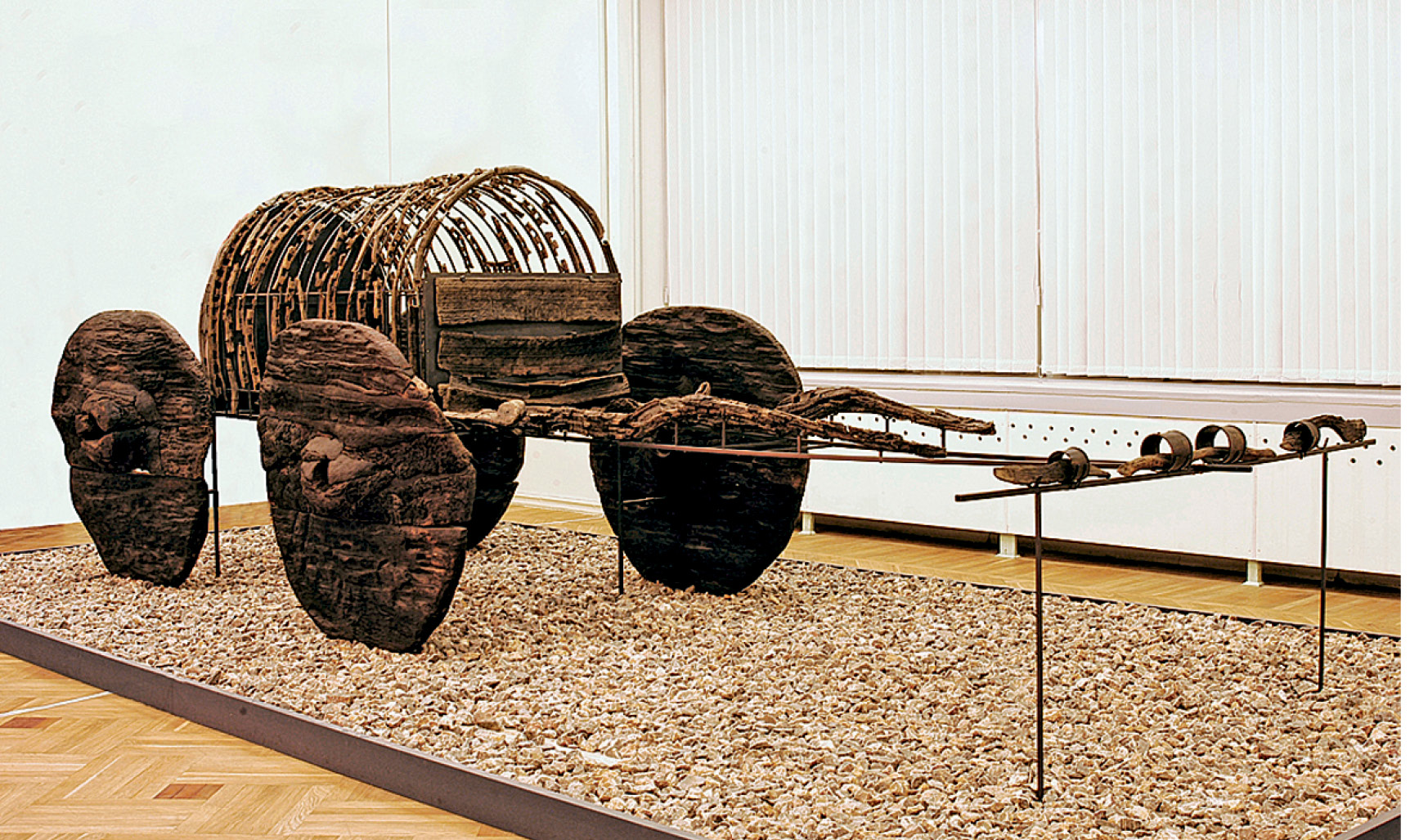left A wooden funeral cart found at Lchashen. inset A bronze model of a fighting chariot.