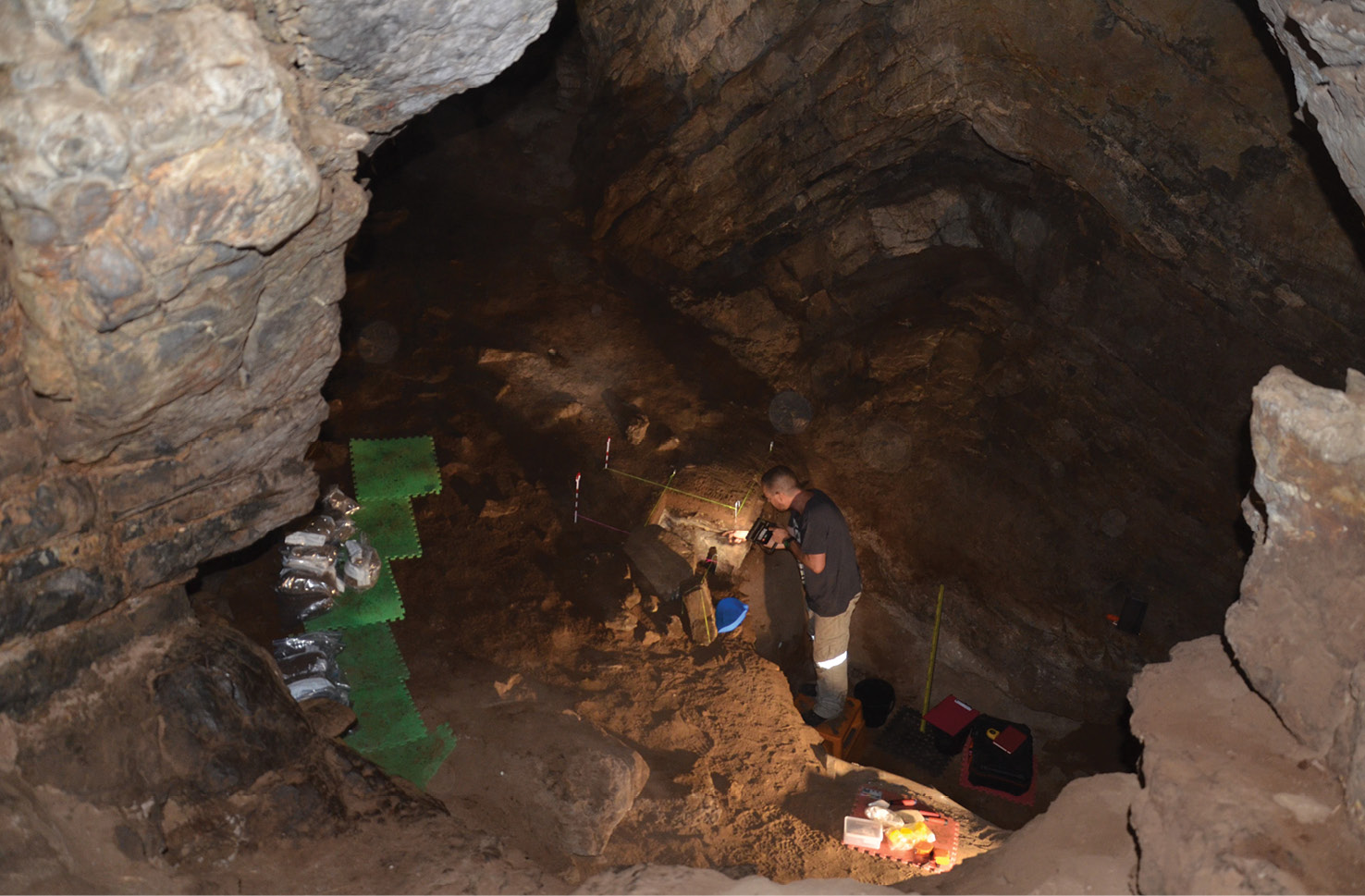 right Excavations under way in the main chamber. Joe Crouch is working on the area where a standing stone will be discovered, beside a pit dug during the 1971-1972 investigations, which has been partly infilled from wall collapses over the following 48 years. This view into the cave was taken from the end of the entrance passage. below right Excavation in progress on the standing stone (just under 30cm tall) found within a series of ashy deposits.