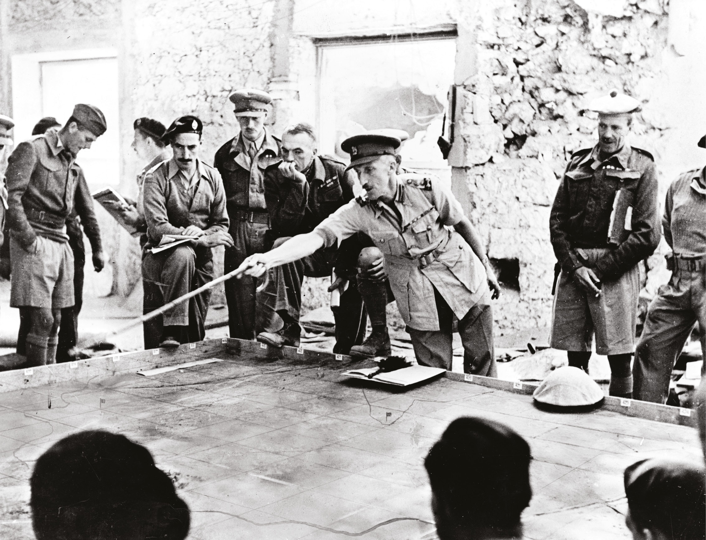 ABOVE British officers plan an operation in the Western Desert. The desert war was to be graveyard of a clutch of British military careers.