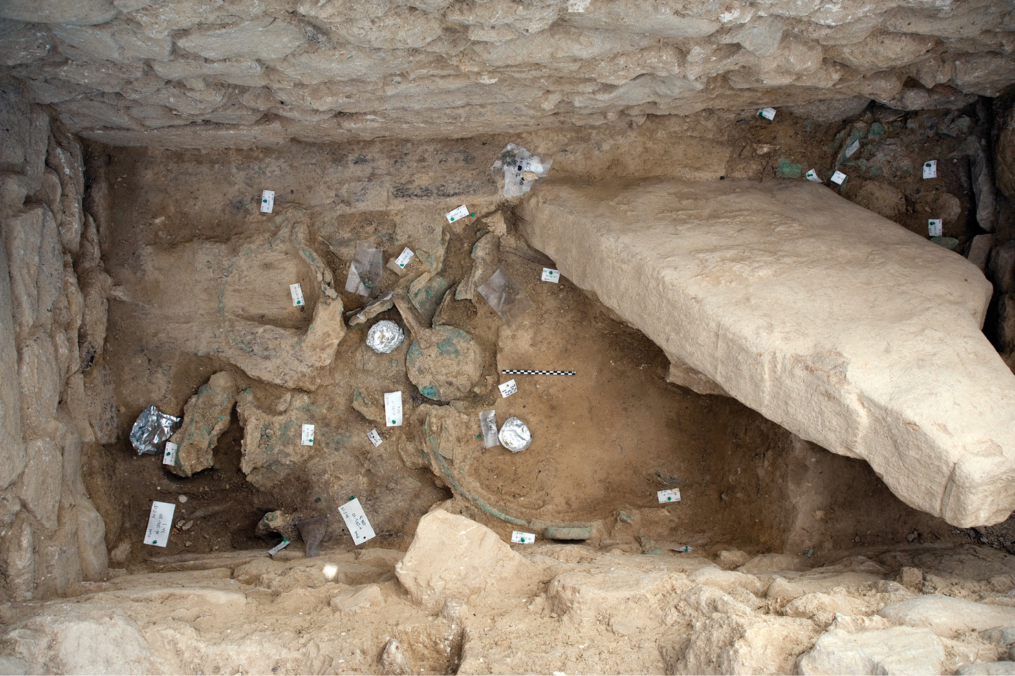 Looking into the tomb of the Griffin Warrior (TOP left); the bronze mirror with ivory handle (INSET left); the gold necklace (ABOVE) and in situ (LEFT); and a decorated ivory comb (FAR LEFT).