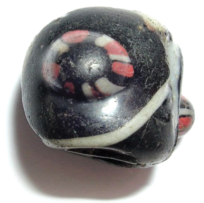 BELOW This glass bead is a rare find, Callmer type B090. It was reportedly found in the walls of Iona’s cathedral in the late 19th century, and speaks of far-reaching connections. Imported from Central Asia, such beads are found in a number of female graves in 10th-century Scandinavia, but few are known in Scotland or Ireland.