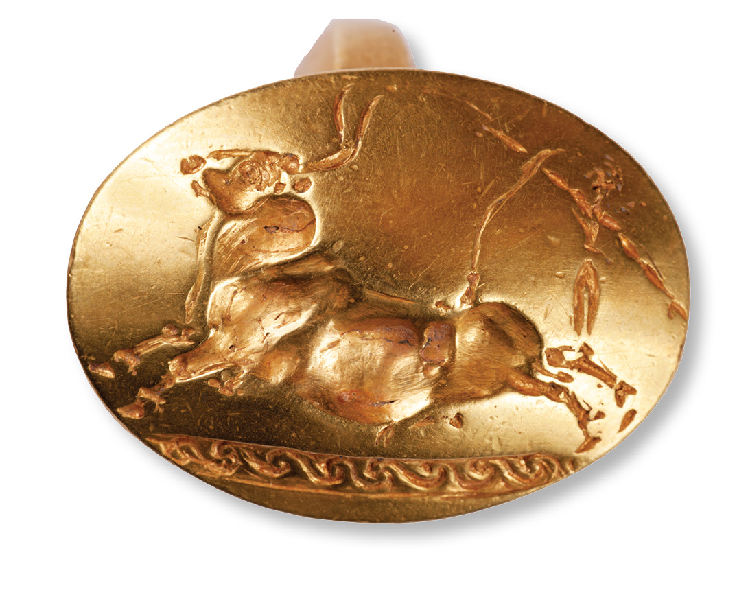 top Gold ring with charging bull and bull-leaper about to complete his jump by landing behind the bull. above Gold ring. In the centre a goddess, carrying a horned staff, descends from on high into a meadow bordered by two rocky peaks on which sit birds.