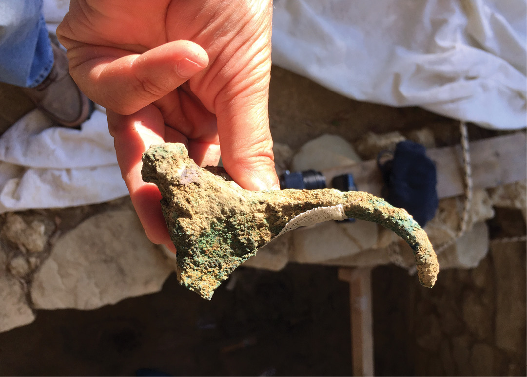 left The bronze bull's head that would have fitted a wooden staff. It looks very similar to the depiction of a staff with prominent horns on one of the gold signet rings (see bottom left in the box above).