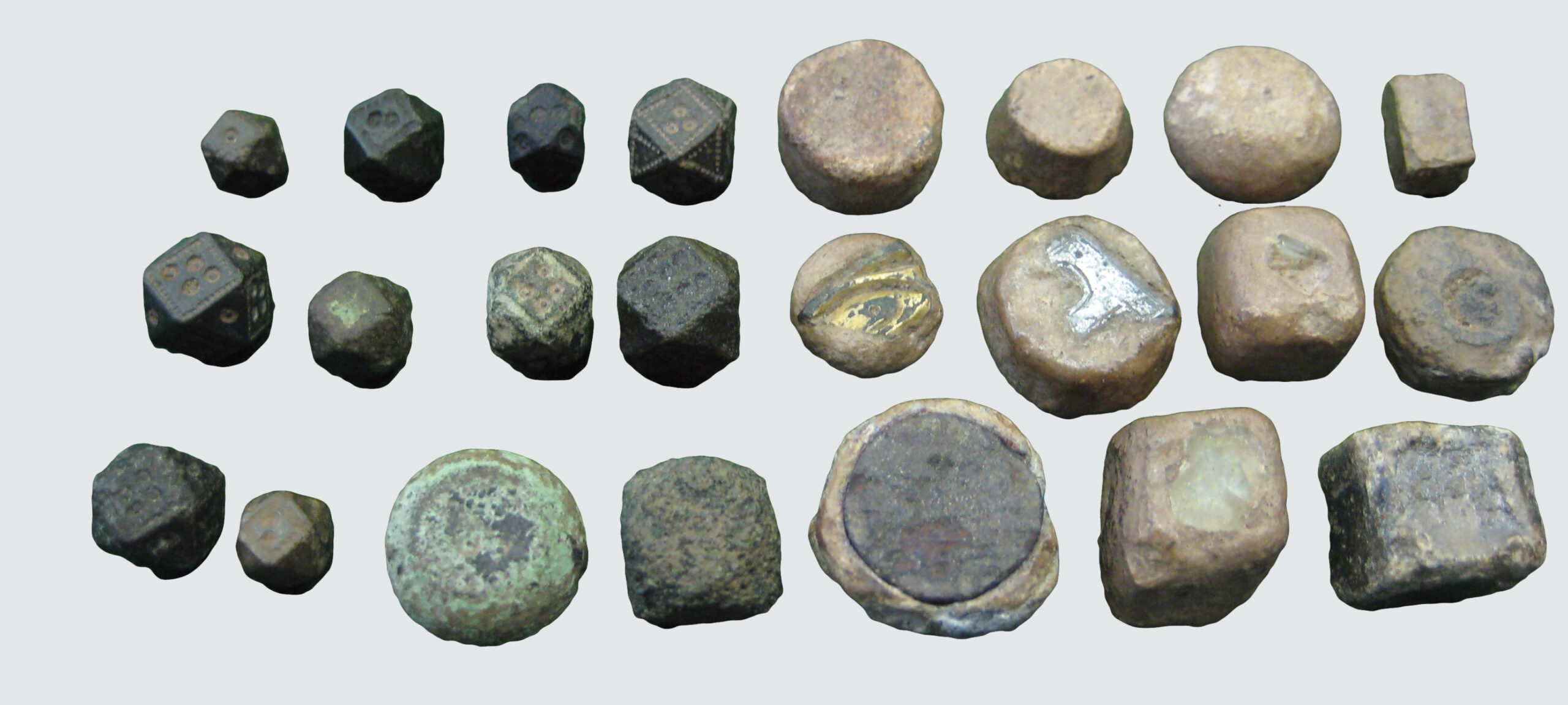 ABOVE A selection of Viking weights from Torksey. On the left, we see examples of copper-alloy cubo-octahedral weights with tiny dots on their faces, which resemble polyhedral dice.