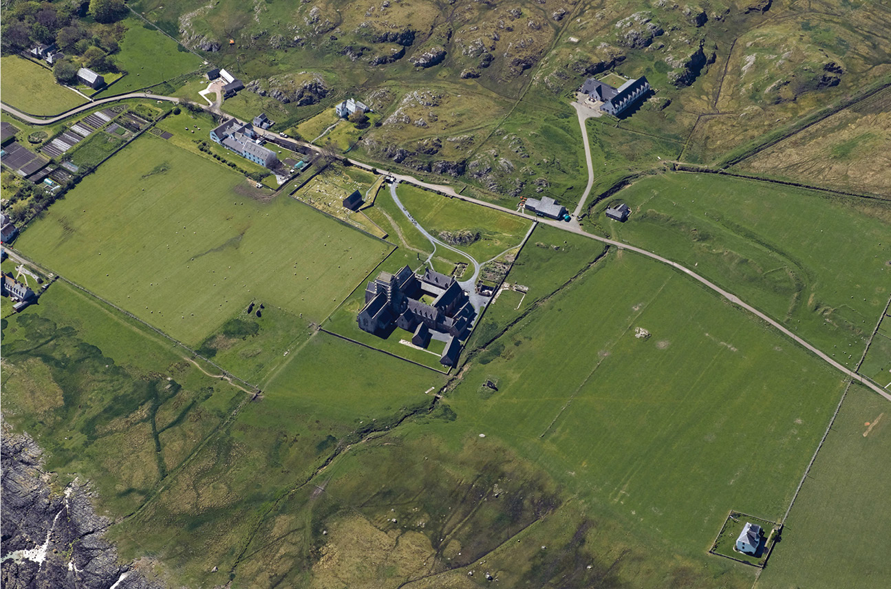 above Since the 1950s, archaeological research on Iona has revealed a palimpsest of earlier features underlying the Medieval monastery, and that many more of the abbey’s features survive within the landscape than was previously thought. Here, traces of the site’s enclosure bank can be clearly seen.