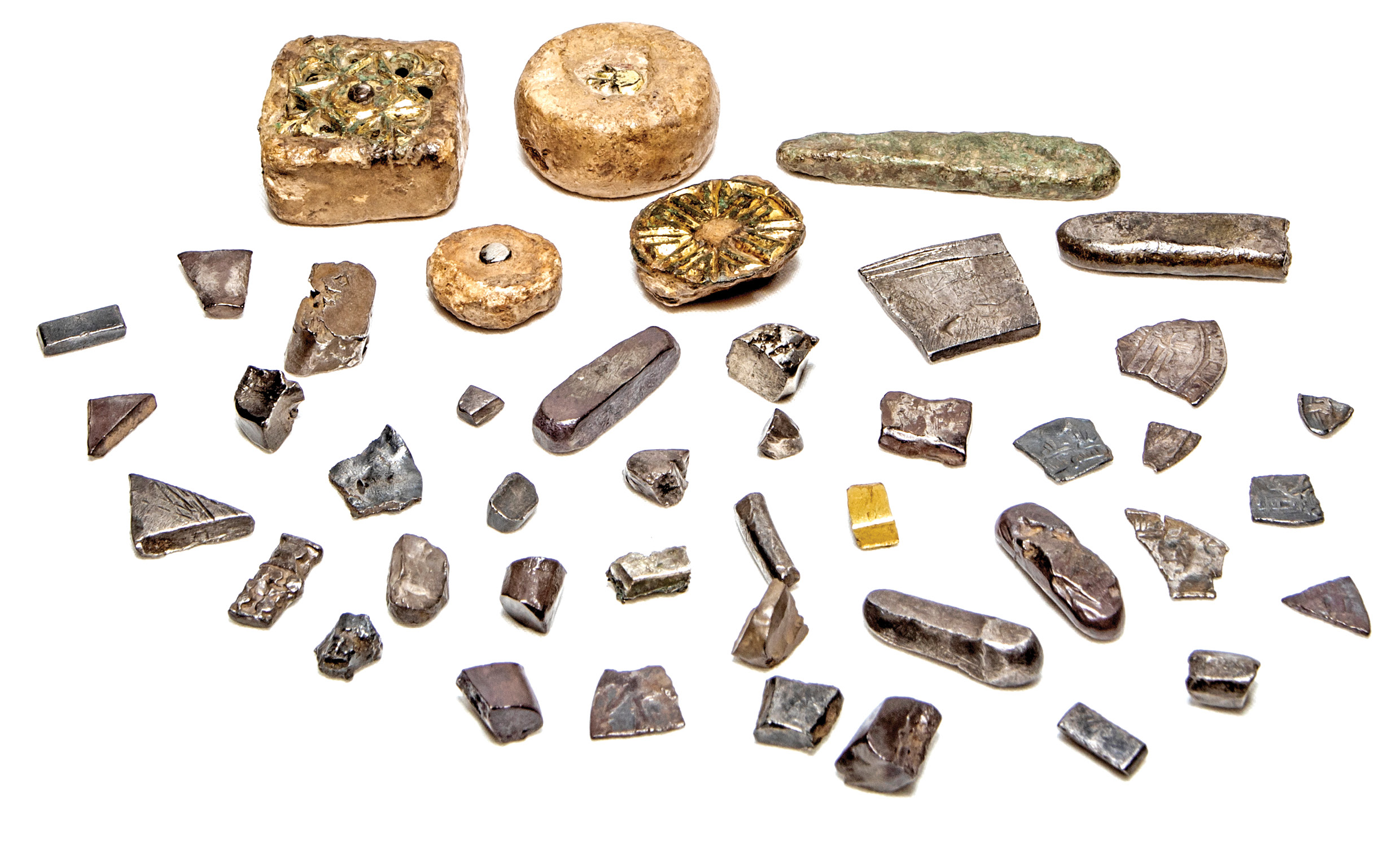 ABOVE A selection of artefacts found at the Viking camp at Aldwark, including four lead weights (top centre left), silver ingots and other hacksilver, and a piece of hackgold.