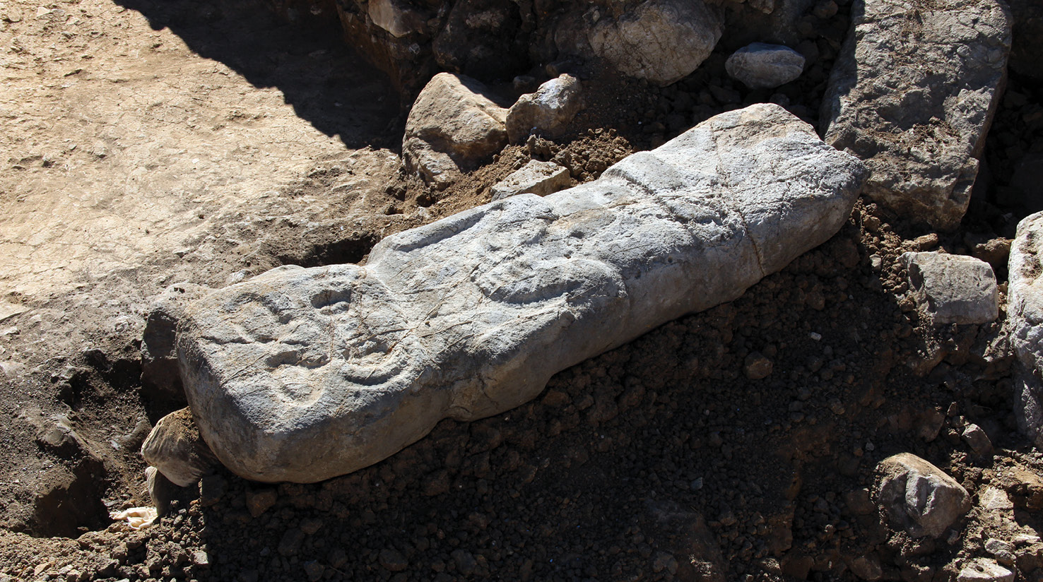 left A carved limestone monolith depicting a human body with a jaguar head.