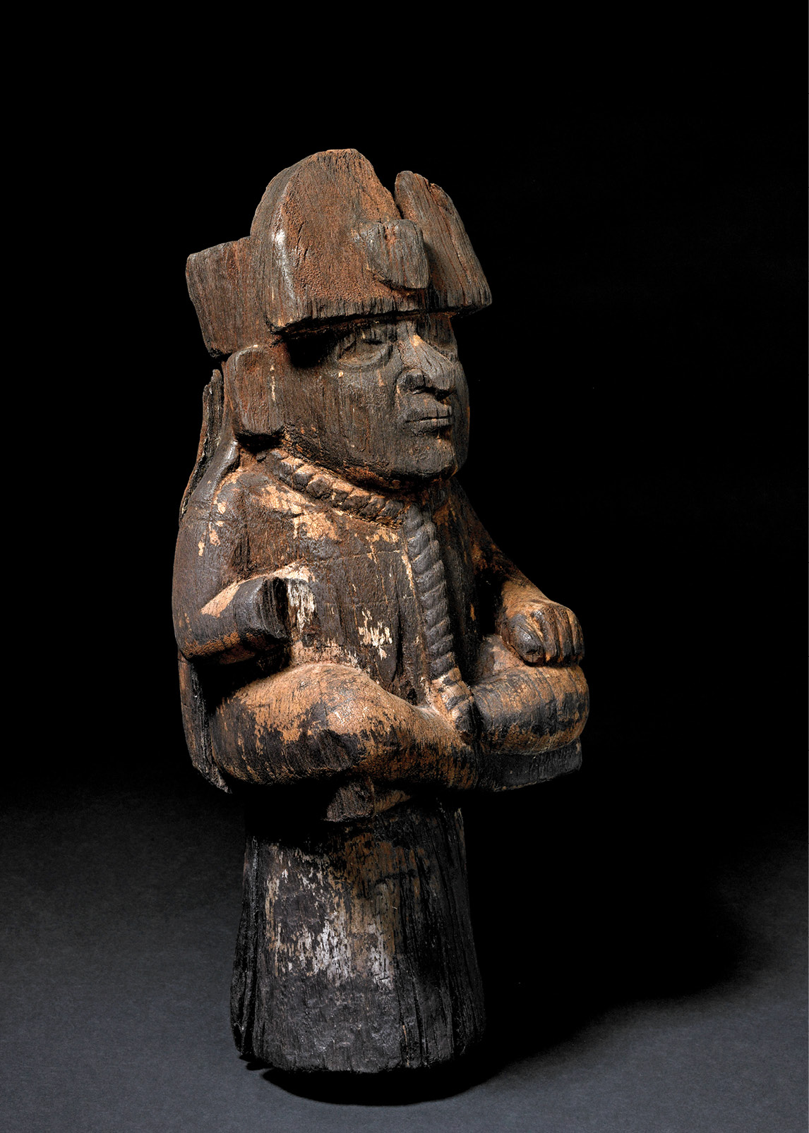 Moche pottery vessels show captives being taken from the mainland in boats (ABOVE). One strong candidate for their destination is the Macabi Islands, where wooden sculptures of bound prisoners were discovered in the 19th century. This example (LEFT) stands 49.5cm high, and shows a captive wearing a headdress, with a rope around his neck.