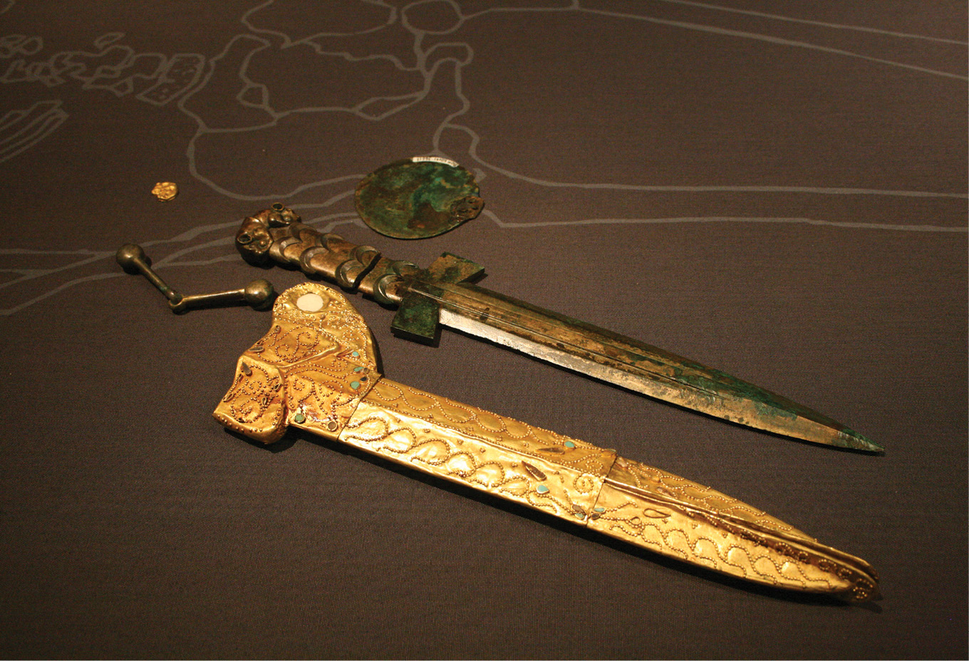 above LEFT The dagger from Kurgan 4 at Eleke Sazy and its gold sheath are both decorated with depictions of predator and prey animals in opposition.