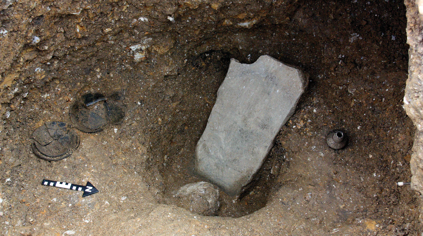 below The grave of the Lady of Pacopampa, showing the slab that covered the burial and ceramic grave goods on either side.