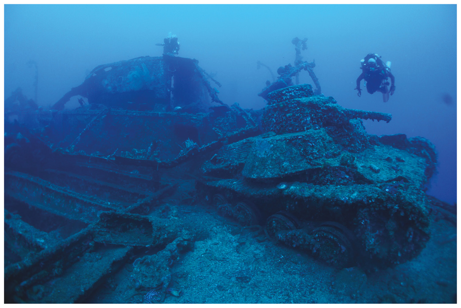 ABOVE A Japanese Type 95 Ha-Gō light tank, carried as deck cargo on San Francisco Maru. RIGHT Hemispherical anti-invasion beach mines stacked in the Tween Deck of the forward holds of the San Francisco Maru.