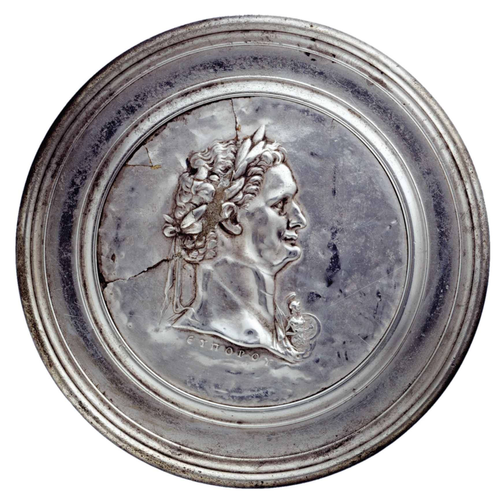 above Silver mirror with a portrait of Domitian on its back and the name of its maker: Europos. Domitian sports a new hairstyle, similar to one of Nero’s, that he adopted in AD 84 to mask his incipient baldness. His opponents called him Calvus Nero (‘Bald Nero’). Northern Iran, AD 81-96. Size: 11.8cm diameter