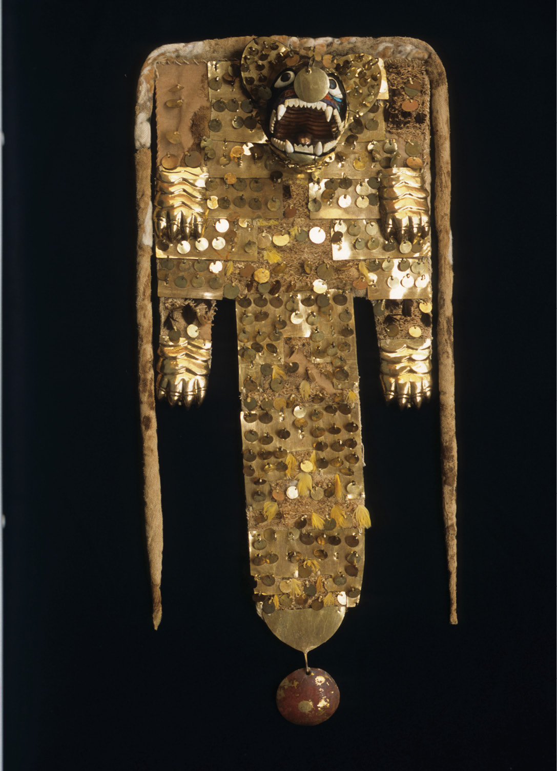 above Ritual cape in the form of a feline. Cotton, copper, resin, semi-precious stones, and feathers; Moche, AD 200-600. Size: 67cm x 29.5cm x 11cm right Stirrup vessel in the form of a portrait head. Pottery; Moche, AD 100-800. Size: 18.9cm x 16cm