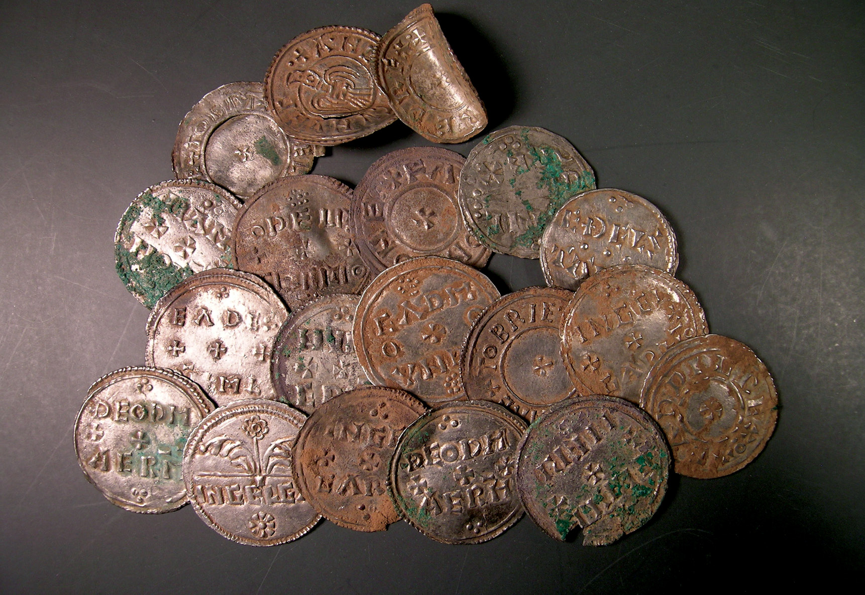 ABOVE The dispersed group of coins at Furness, which alerted the finder that he was dealing with a hoard. INSET Ingots and arm-ring fragments from the Furness Hoard. The two curved fragments (top left) fit together to form a complete ring.