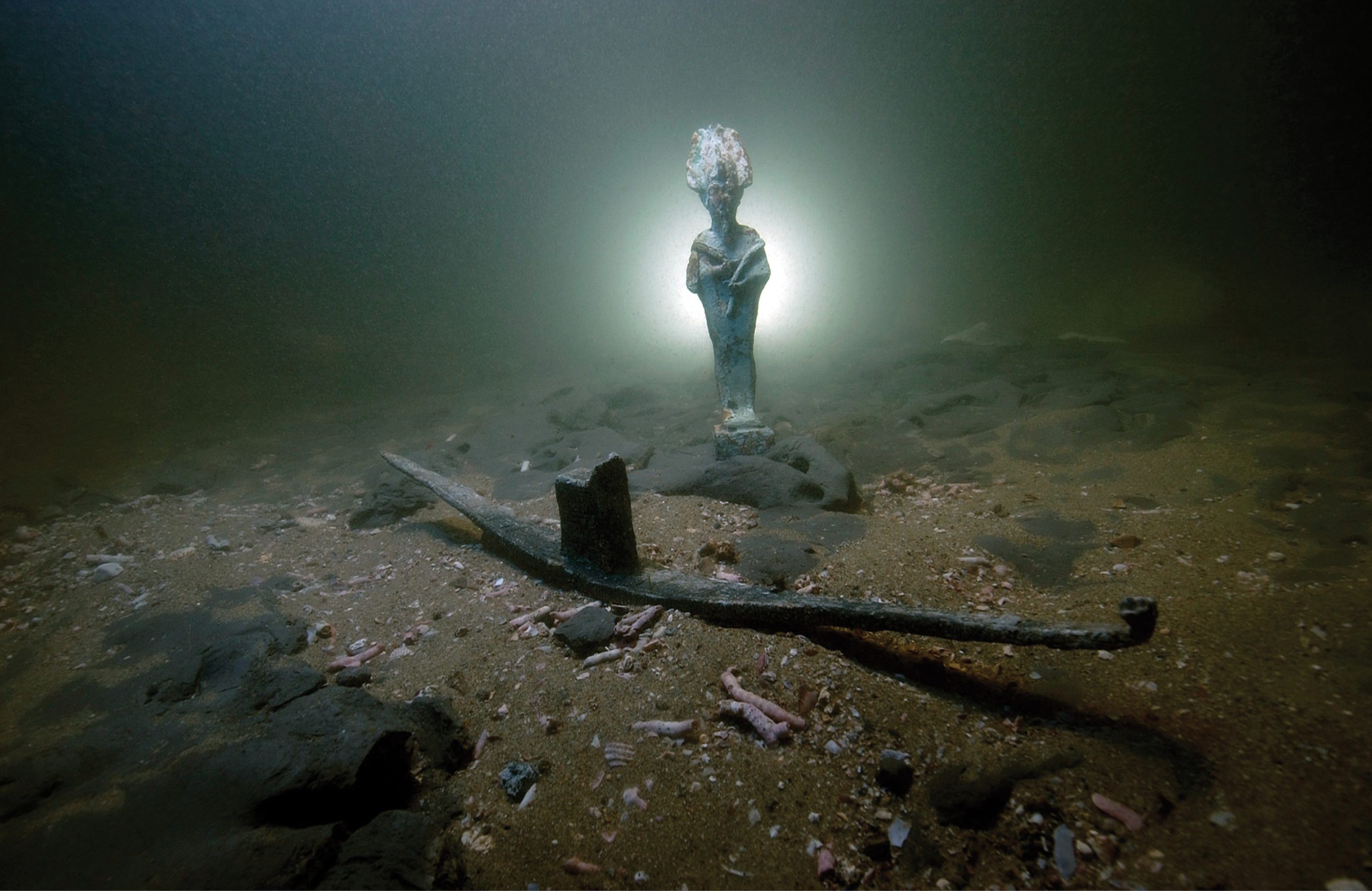 below Lost with the city of Thonis-Heracleion, this votive boat and statuette of Osiris were used in the religious ceremonies of the city at the end of Late Egyptian period or early Ptolemaic period, c.4th 2nd century BC.