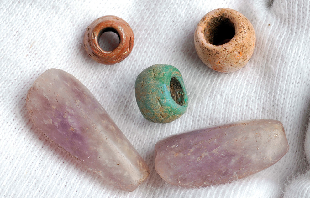 Left Anglo-Saxon beads of c.AD 650-670, found on the St Martin-in-the-Fields site on the edge of Trafalgar Square, representing an early phase in the development of the emporium. Above An Anglo-Saxon silver finger-ring of c.AD 650 from early Lundenwic. Right A decorated escutcheon (attachment) from a hanging bowl of c.AD 650 from early Lundenwic.