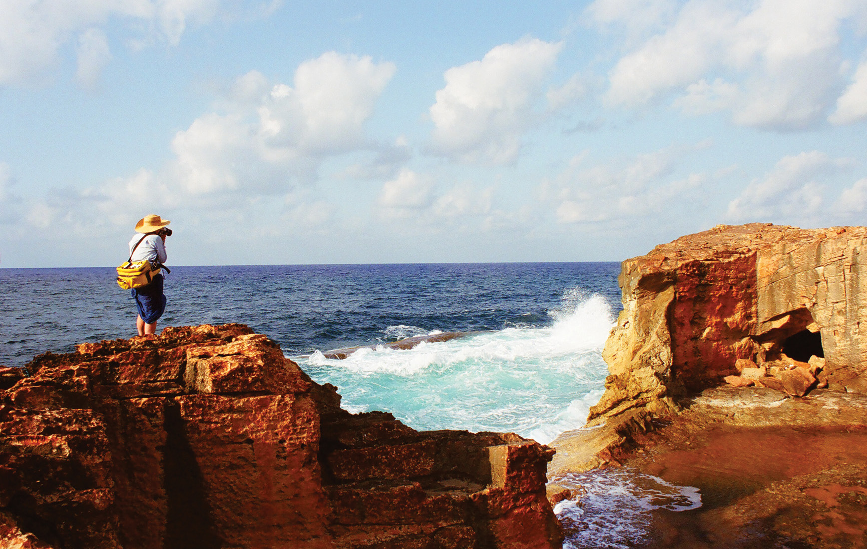 LEFT My wife, Jay Kleinberg, photographs the gap left by the smashed rock wall that was broken through by the waves after 1959. Compare with the photograph on p.43. You can see the top of the wave-trap ridge immediately beyond the foaming white water. The dark entrance cut into