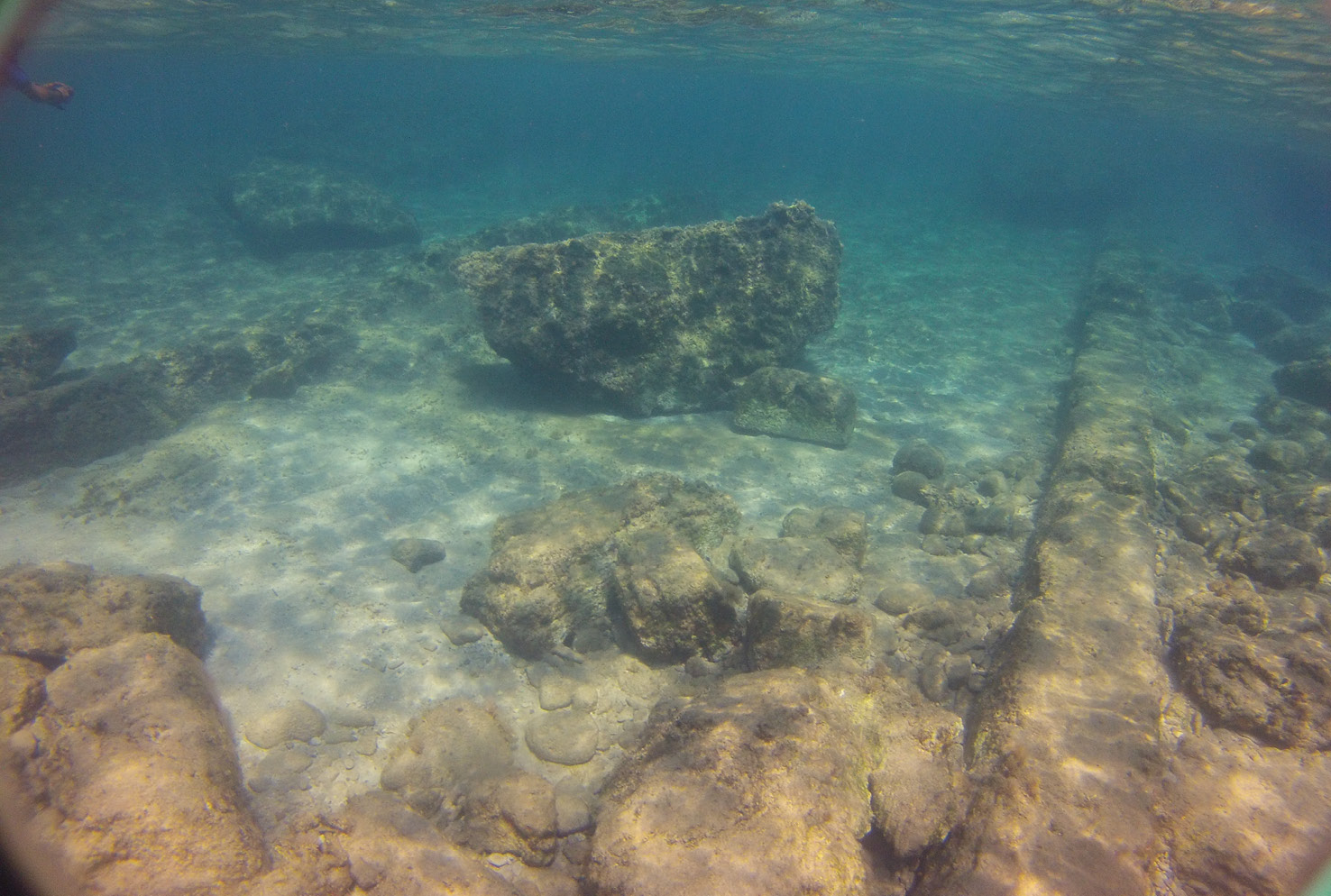 BELOW LEFT Numerous slabs of rock weighing more than 10 tonnes each are the remains of the smashed rock wall from the north side of the West Island. They have been rolled on to the sloping surface of the early Greek slipways that were built to protect the war galleys.