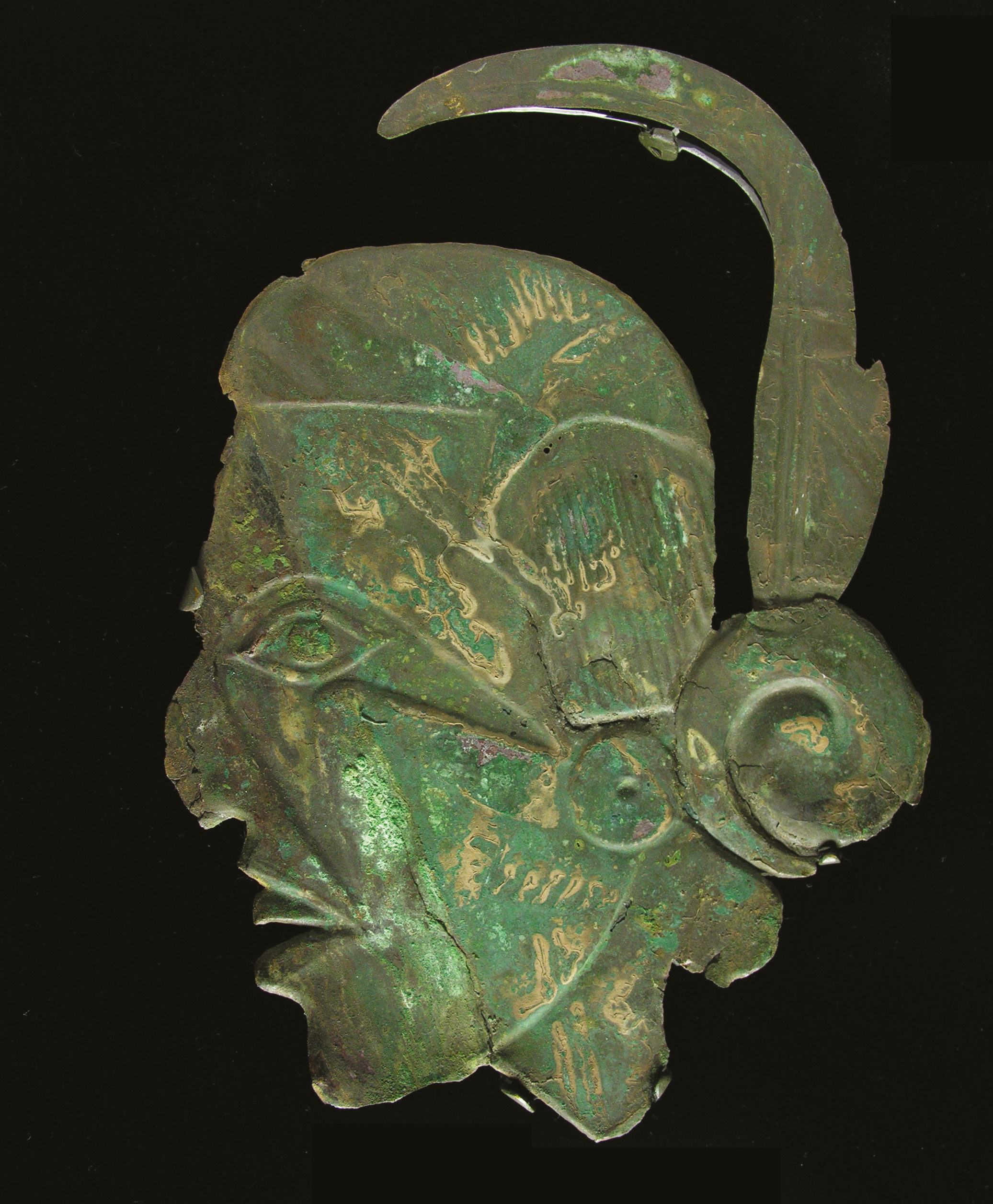 right Human head effigy plate, from Spiro. Copper, AD 1200-1450. Size: c.30 x 20cm