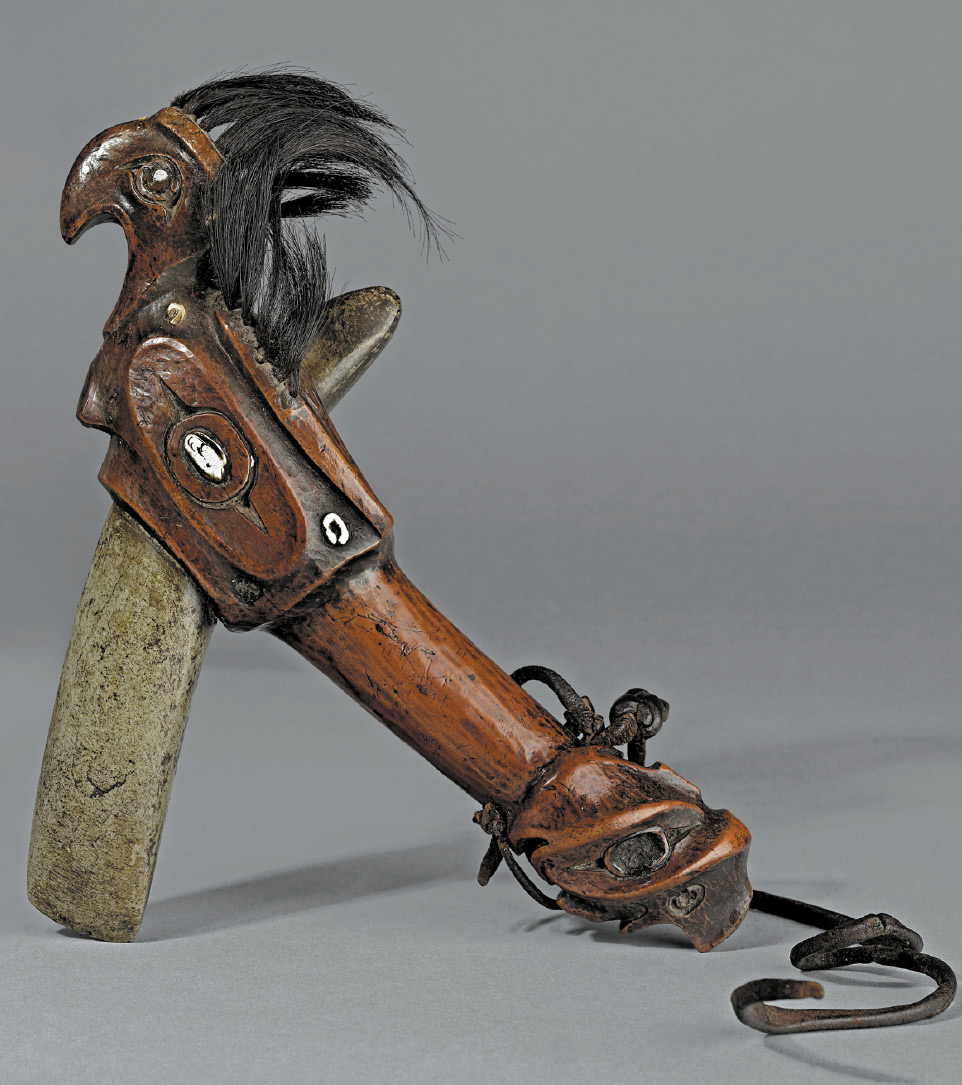 13. Nuu-chah-nulth ceremonial club made of yew wood and steatite in the shape of a Thunderbird with inlaid operculum shells and sea otter teeth. The club may have been collected by Captain Cook on his third voyage 1776-1780 in Nootka Sound, British Columbia Canada.