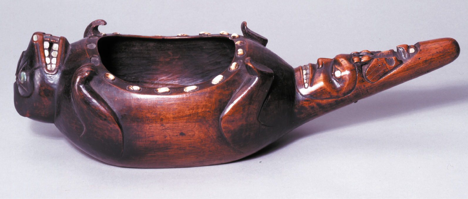 8. Haida dish carved in the shape of a beaver or marmot with faces depicted on the tail, probably used in potlatch ceremonies to share oil and display the owner’s crests to guests of the potlatch.