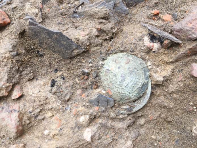 ABOVE Two of the Scots Guards’ buttons were found ‘clasped’ together, suggesting that they were probably still attached to fabric at the time of burial.