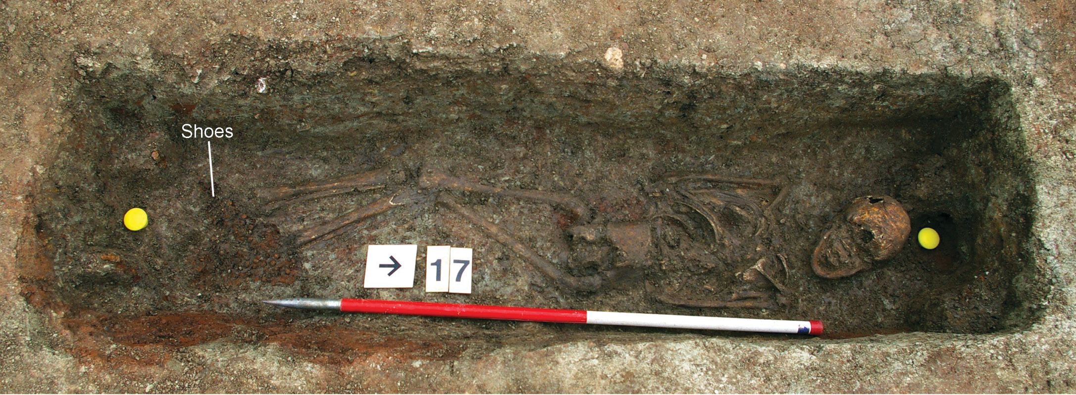 above This adolescent (aged 12-14) was buried prone in a wooden coffin. Iron hobnails cover the feet, showing that they were buried wearing shoes. A ceramic jar was also placed on top of the coffin.