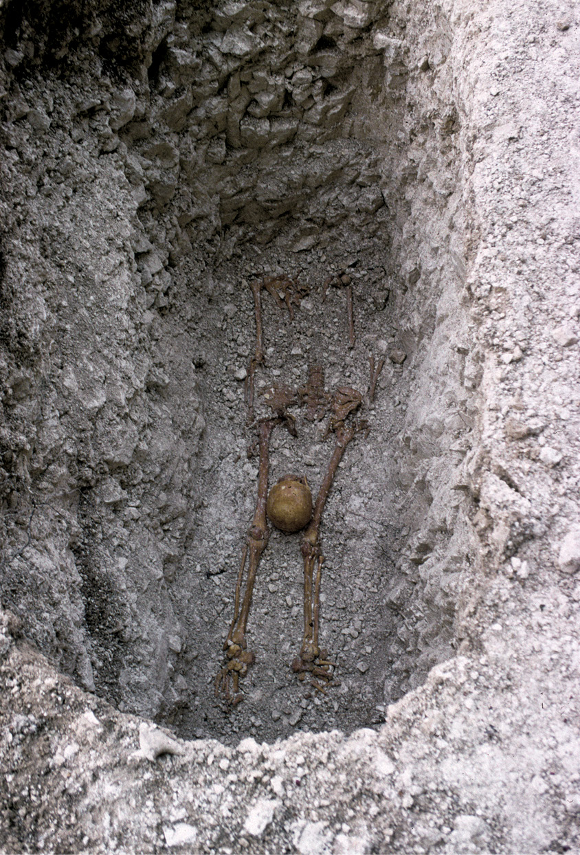 ABOVE This decapitation burial was of a 26- to 35-year-old female. A coin of AD 350-364 was placed within her coffin, while flint packing stones were wedged alongside her coffin. ABOVE RIGHT A prone burial of a male aged over 60, with his hands seemingly bound at the wrists.
