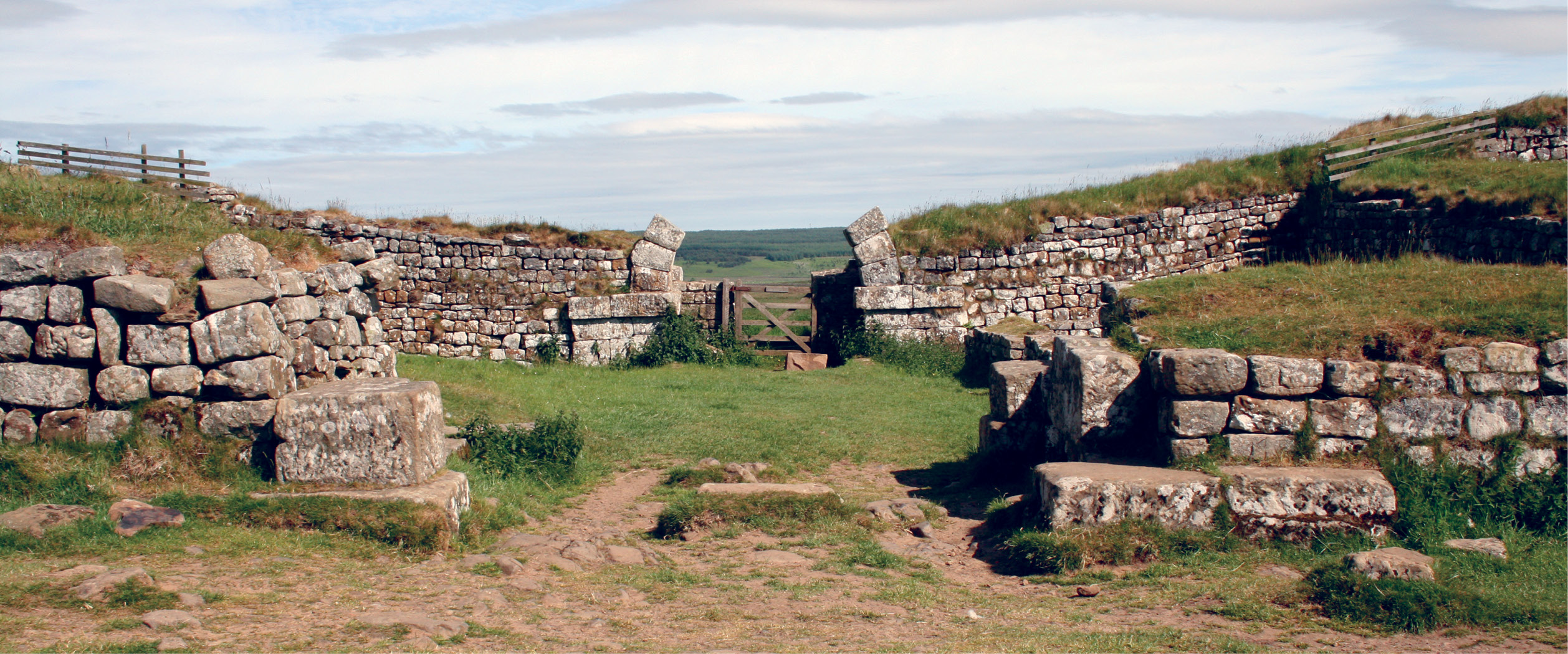 ABOVE The Roman presence: Hadrian’s Wall was not a closed frontier.Milecastles positioned at regular intervals along its course allowed north south movement, whether for military or civilian traffic remains disputed. When the army reoccupied southern Scotland under Antoninus Pius, military structures were built in their wake, including this fortlet at Durisdeer (Inset). BELOW This distinctive type of armlet, decorated in a Celtic artistic style, was made in the north-east of Scotland in the later 1st or 2nd century AD a statement of identity in the face of the Roman threat? The example shown, from Auchenbadie (Banffshire), was made from reused Roman metal.