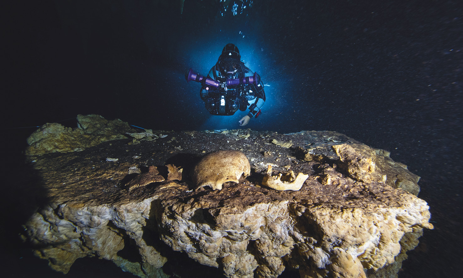 LEFT A portion of a Maya skull is recorded by the Great Maya Aquifer project team in the depths of a cenote in Quintana Roo.