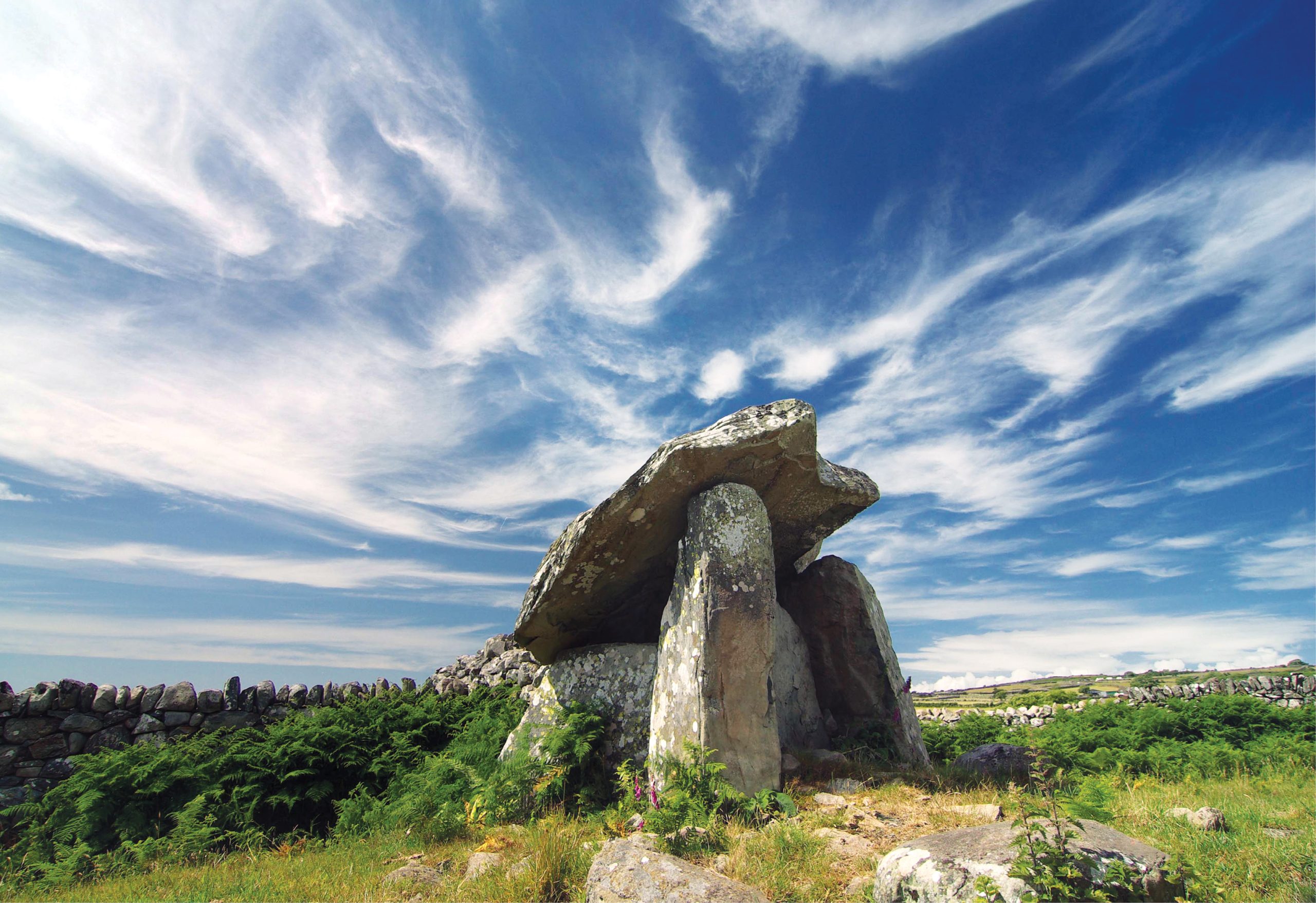 LEFT Gwern Einion’s steeply sloping capstone stands against a dramatic sky in Gwynedd. What was the purpose of dolmen monuments like these, and were they always denuded stone frames, or had they originally been covered by mounds of earth?