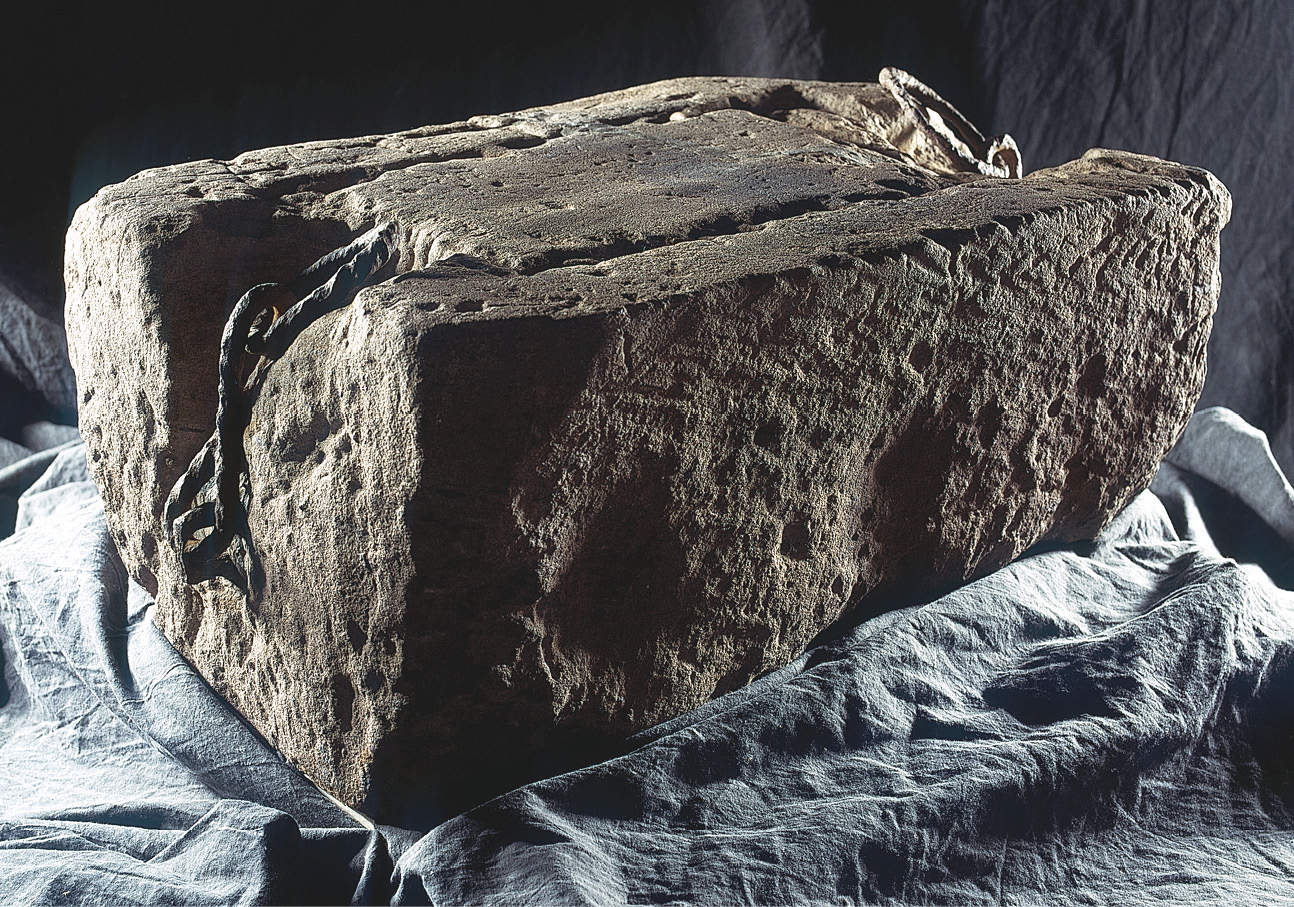 below The Stone of Scone. This iconic artefact has been the subject of many a pseudo-history, but the most recent study has revealed that much can be learnt about the object’s current appearance by considering it alongside the Coronation Chair. This photograph, for instance, shows the front of the stone and the hollows caused by visitors scraping it to obtain dust. These hollows coincide with the positions where the shields had been lost from a grille that formed part of the fabric of the chair.