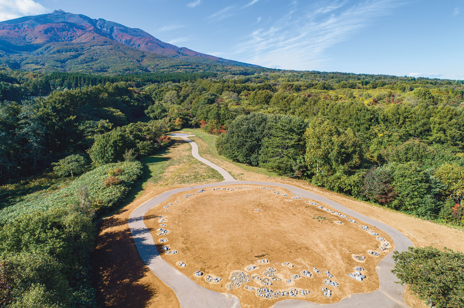 The stone circle at Omori-Katsuyama was created about 3,000 years ago and occupies a conspicuous point in the landscape at the foot of Mount Iwaki (LEFT). Hundreds of enigmatic stone discs have been found at the site (ABOVE).