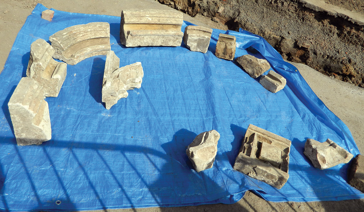 below Architectural fragments from the church’s great east window, found in trench 3. right Copper alloy letters found during the excavation. Are these from tomb inscriptions?