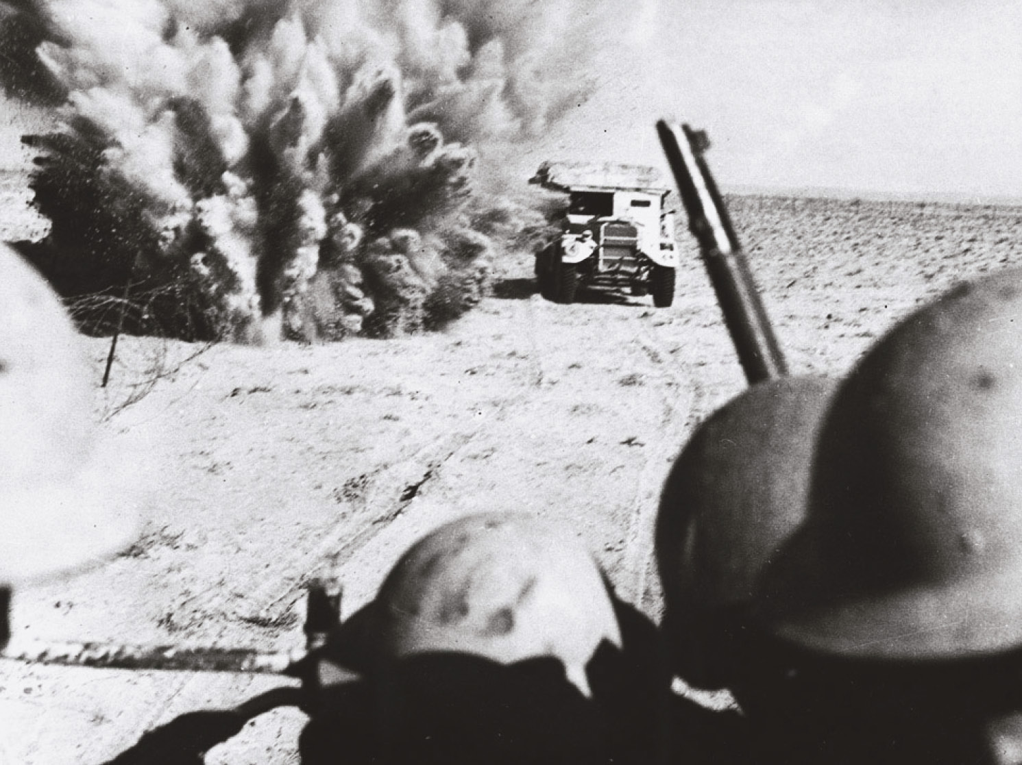 RIGHT A mine explodes close to a British artillery tractor as it advances through enemy minefields at El Alamein, October 1942. British and Commonwealth troop losses were to prove more sustainable than those of their opponents.