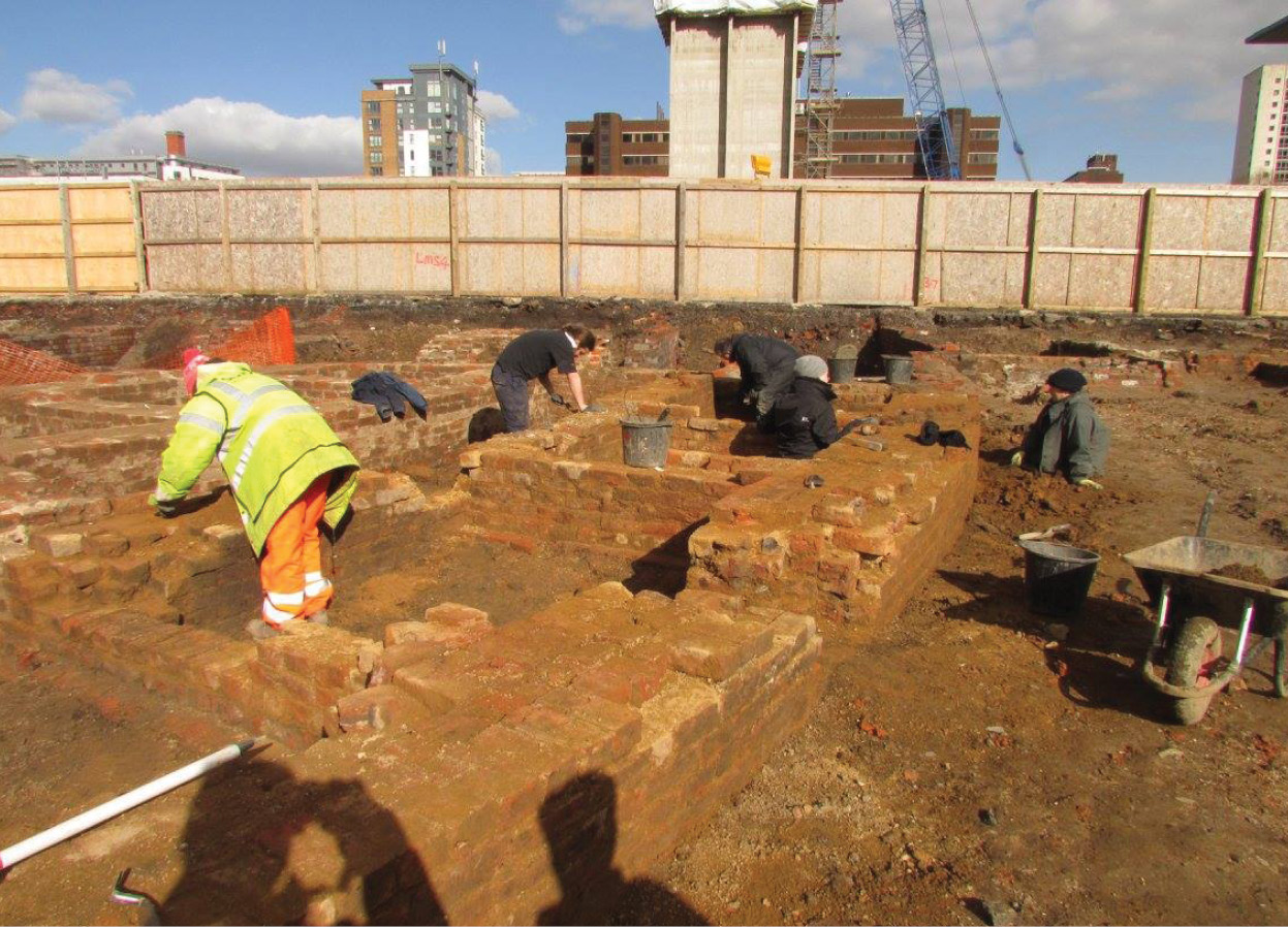 above Hemmed in by rather more modern walling, the University of Salford team investigate some of the male felon cells.