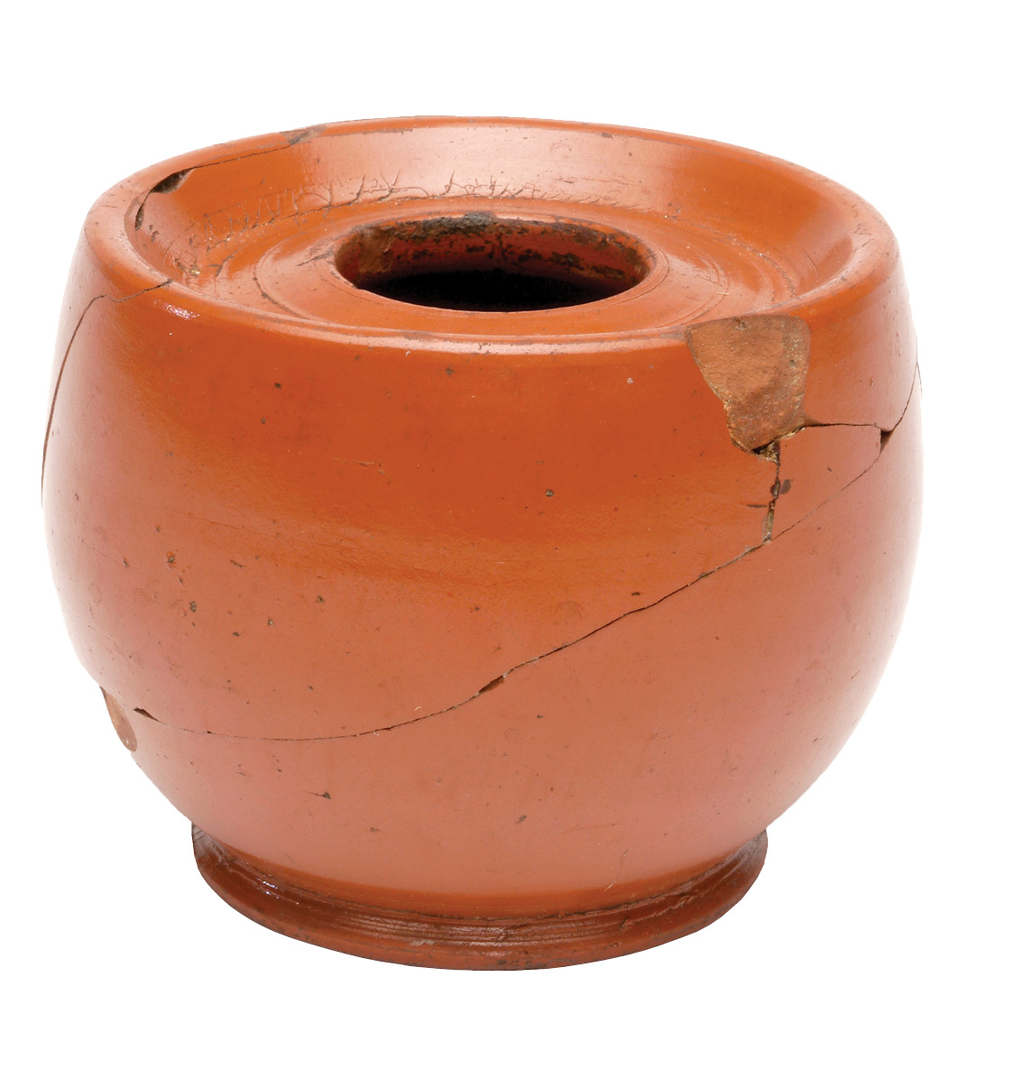 far left A Samian inkwell, now held by the Museum of London. These are the most-common form of inkwell found in Roman Britain, and over 130 have been found in London alone. LEFT An elegant inkwell from Chichester. The small knob on top permitted a catch on the underside of the lid to be manipulated into a locked or open position. This prevented spillages if the inkwell was knocked over, and also helped keep the ink from drying out.